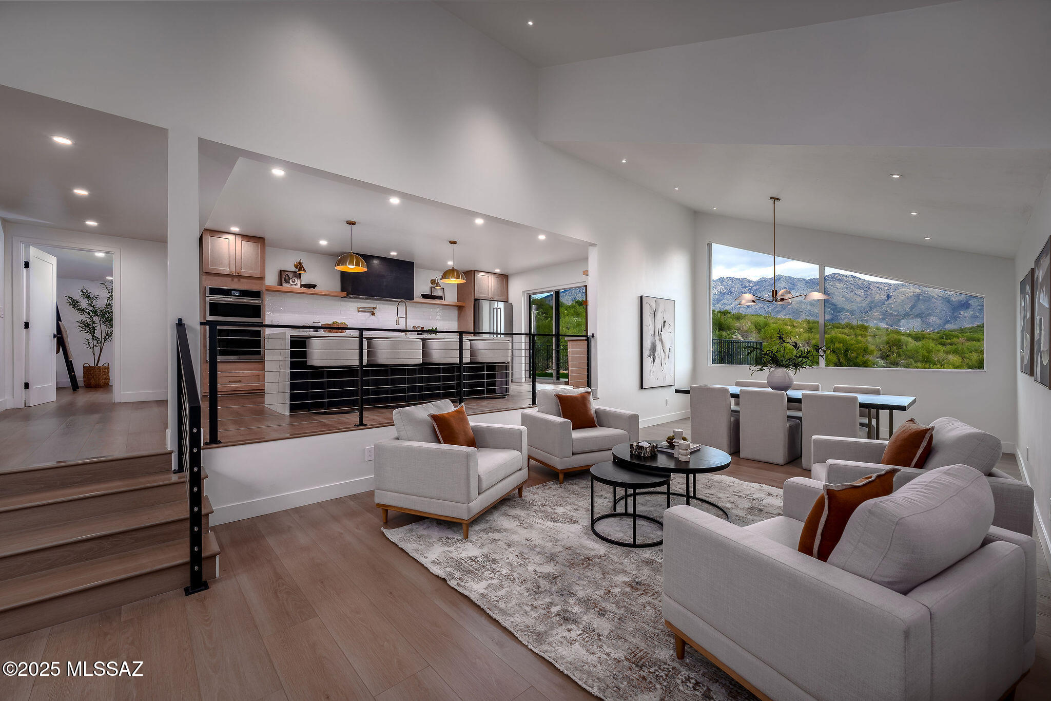 Views, Views, Views! This fully renovated home offers breathtaking mountain views and is located in the prestigious Catalina Foothills surrounded by upscale shopping, resorts, restaurants, golf, and scenic hiking and biking trails. Meticulously remodeled, the home features an oversized 3-car garage, four large bedrooms, and four beautifully appointed bathrooms, with no expense spared. Highlights include a new roof, dual new HVAC systems, Dryvit synthetic stucco exterior, new dual-pane windows and sliders, extensive electrical and plumbing upgrades, and WiFi-enabled systems throughout. The thoughtfully reimagined floor plan showcases engineered wood flooring, solid-core interior doors, custom finishes, recessed LED lighting, and expansive windows designed to maximize the stunning views The great room stuns with exposed wood beams, oversized windows, and seamless indoor-outdoor flow. The chef's kitchen is a true showpiece, featuring Legend soft-close cabinetry, Calacatta Oro quartz countertops, a dramatic waterfall island, concealed LED accent lighting, a 48" Forno gas range with dual ovens, premium stainless steel appliances, champagne bronze fixtures, and an oversized stainless-steel sinkperfect for entertaining.

Outdoor living is exceptional with a fully refreshed pool, new decking and patio areas, synthetic turf, wrought-iron view fencing, low-maintenance composite decking, and professionally designed landscaping with lighting and irrigation ideal for enjoying sunrise and mountain backdrops.
The luxurious primary suite offers an 8-foot sliding glass door framing the views, custom lighting, a spa-inspired bath with dual vanities, rain shower, Toto bidet, and a fully built-out custom closet. Additional bedrooms include a junior suite with private bath, upgraded secondary bathrooms, and a custom wine area for the enthusiast.
Completing the home are an oversized 3-car garage with insulated decorative doors, a newly installed concrete driveway, WiFi-enabled openers, epoxy floors, EV charging capability, and a gas water heater with programmable recirculation. This is a rare opportunity to own a turnkey, designer-finished home in one of Tucson's most sought-after locations and one of the best view lots in the Foothills.