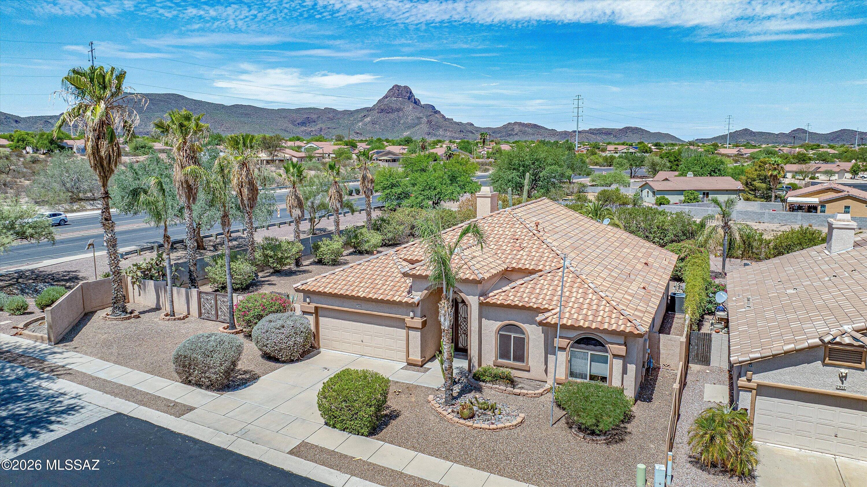 Set on a large .37-acre corner lot, this single-owner home offers a split-bedroom floor plan, high ceilings, and an open-concept Great Room. The kitchen shines with granite countertops, stainless steel appliances, gas range, and kitchen island with breakfast bar. Roof was replaced in 2021, and new AC installed in 2023. Enjoy a Pebble-Tec pool surrounded by beautiful low-care landscaping with mature cacti and palms. Conveniently located on Tucson's Northwest side, just minutes from I-10 and walking/biking distance to The Loop, shopping, grocery stores, schools, parks, the public library, and community amenities. Third bedroom can easily be converted back into two separate bedrooms.