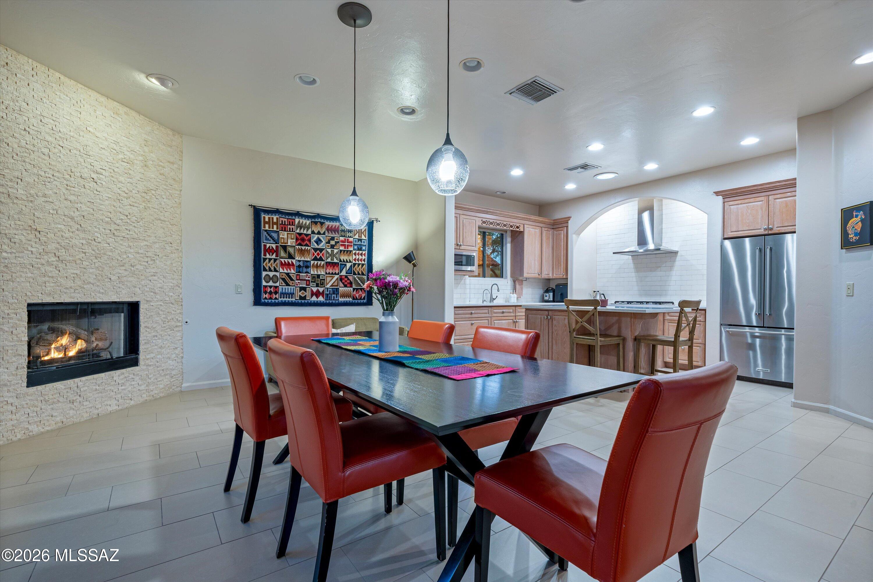 Former model home in desirable gated Vactor Ranch on an elevated lot with surprising views! The great room showcases a beautiful fireplace with split-face travertine ledger stone and opens to updated kitchen with quartz counters, porcelain subway tile backsplash, and KitchenAid range, oven, refrigerator & dishwasher, plus stainless range hood. Porcelain flooring in living areas & baths. Primary bath w/walk-in shower & separate jacuzzi tub. Custom blackout blinds in bedrooms, fresh interior paint, and newer bedroom carpet & ceiling fans. Front courtyard w/pavers and shade tree. Insulated garage w/epoxy floor & EV charger. Newer roof, water heater, LG washer/dryer, GE microwave, water softener. This home has been meticulously maintained with all the right upgrades. Welcome Home!