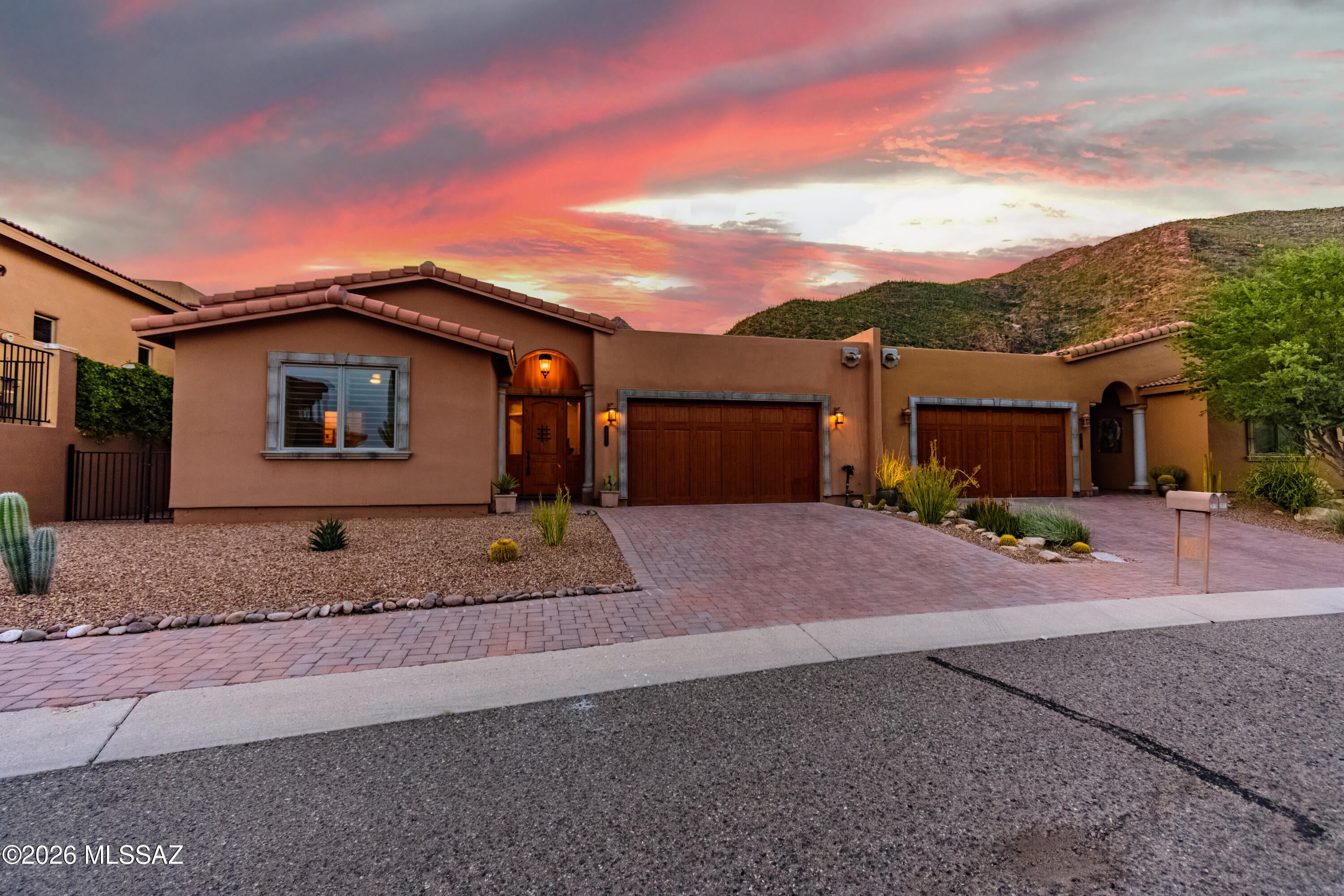 An exceptional convergence of setting, style and sophistication, this nearly new luxury Villa Milano  townhome enjoys unobstructed Catalina Mountain views from within Rancho Sin Vacas, one of the Foothills' most desirable guard-gated communities. Nestled high against the mountain and completed in 2022, this exceptional 2-bedroom, 2.5-bath residence was thoughtfully positioned to capture breathtaking views of the Catalinas towering above--a combination increasingly difficult to find in the  Foothills.

Designed for sophisticated, low-maintenance living without compromising comfort or luxury, the home offers generous entertaining spaces flooded with natural light from expansive windows, complemented by wood plantation shutters and soaring ceilings. A clean, organic contemporary aesthetic.. carries throughout the residence, with a refined palette of calming colors, natural textures and thoughtfully selected finishes creating an atmosphere that feels both elevated and inviting.

At the heart of the home, the beautifully appointed gourmet kitchen opens seamlessly to the living and dining areas and features a striking marble backsplash, granite slab countertops, stainless steel appliances, abundant workspace and bar seating--equally suited to casual everyday living or entertaining family and friends.

The spacious primary suite is a private retreat with direct access to the rear patio, a beautifully finished bath with walk-in shower and a custom-designed closet system. The well-appointed guest suite provides excellent privacy, while an additional powder room is ideally situated for guests. For those requiring additional workspace, the floor plan also provides an opportunity to create a private study or den.

Multiple outdoor living areas embrace the home's extraordinary setting, offering intimate spaces for morning coffee, alfresco dining, evening cocktails with the neighbors or simply taking in the dramatic Catalina Mountains and surrounding Desert landscape. A shaded side yard extends the length of the home, providing a private outdoor space for the four-legged member of the household.

Outside, smooth-finish stucco complemented by beautifully stained natural-wood entry and garage doors creates a refined architectural presence, while thoughtfully designed desert landscaping reinforces the home's effortless lock-and-leave appeal.

Additional amenities include tile flooring throughout, walk-in showers, custom closet systems, whole-home water filtration, extensive recessed lighting, ceiling fans, two new all-in-one front-load washer/dryer units and an attached 2-car garage. Residents of Rancho Sin Vacas also enjoy a beautiful community pool and spa overlooking the surrounding desert landscape, with sparkling city lights providing a dramatic backdrop after sunset.

The location is equally exceptional. Less than five minutes from La Encantada and its acclaimed restaurants and luxury shopping, the residence also offers convenient access to the Pima Canyon, Finger Rock and Pontatoc Ridge trailheads, as well as nearby La Paloma Country Club, featuring a 27-hole Jack Nicklaus Signature golf course along with tennis, pickleball, fitness and dining.

Nearly new construction. Guard-gated security. Luxurious finishes. Effortless lock-and-leave living. And unobstructed Catalina Mountain views. Together, they create an offering seldom found in such a coveted central Foothills location--equally compelling as a sophisticated full-time residence or an exceptional seasonal retreat.