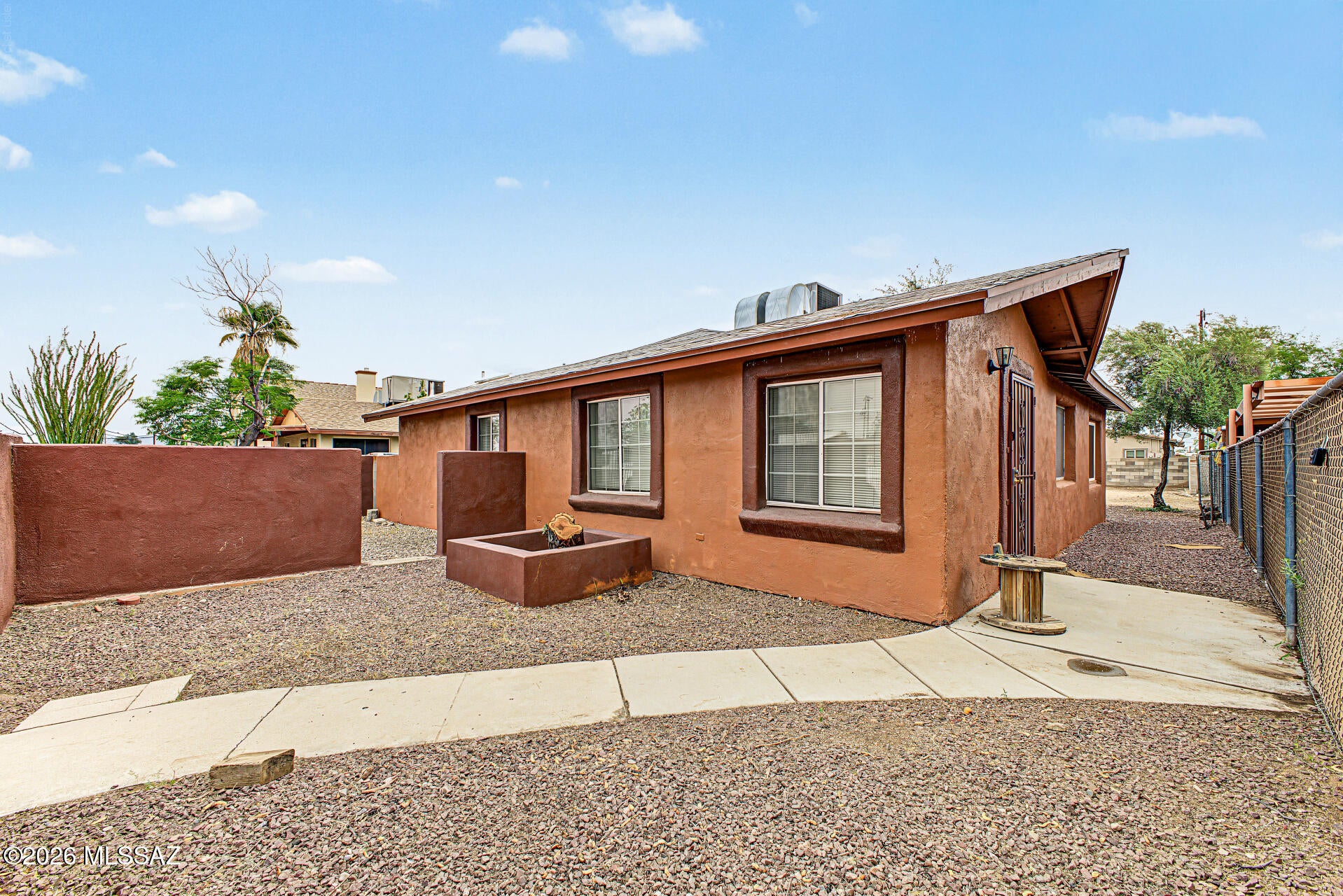 Beautiful 2 bedrooms, 2 bathrooms on a large R2 Lot. Imagine the possibilities.  Fully fenced yard with gated front parking, and a low-care landscape with mature shade trees. Inside, you'll find abundant natural light, a neutral palette, tile floors throughout, and an inviting living area. The eat-in kitchen boasts ample wood cabinetry & counter space, built-in appliances, and a breakfast room. The sizable main bedroom includes generous closet space and a private bath with a tiled shower. A secondary bedroom includes a laundry area for added convenience. Outside, multiple seating areas, an RV gate & parking, and plenty of open space offer the potential to create your own private retreat. Conveniently located near shopping and dining, with access to I-10 and downtown Tucson. Move-in ready!
