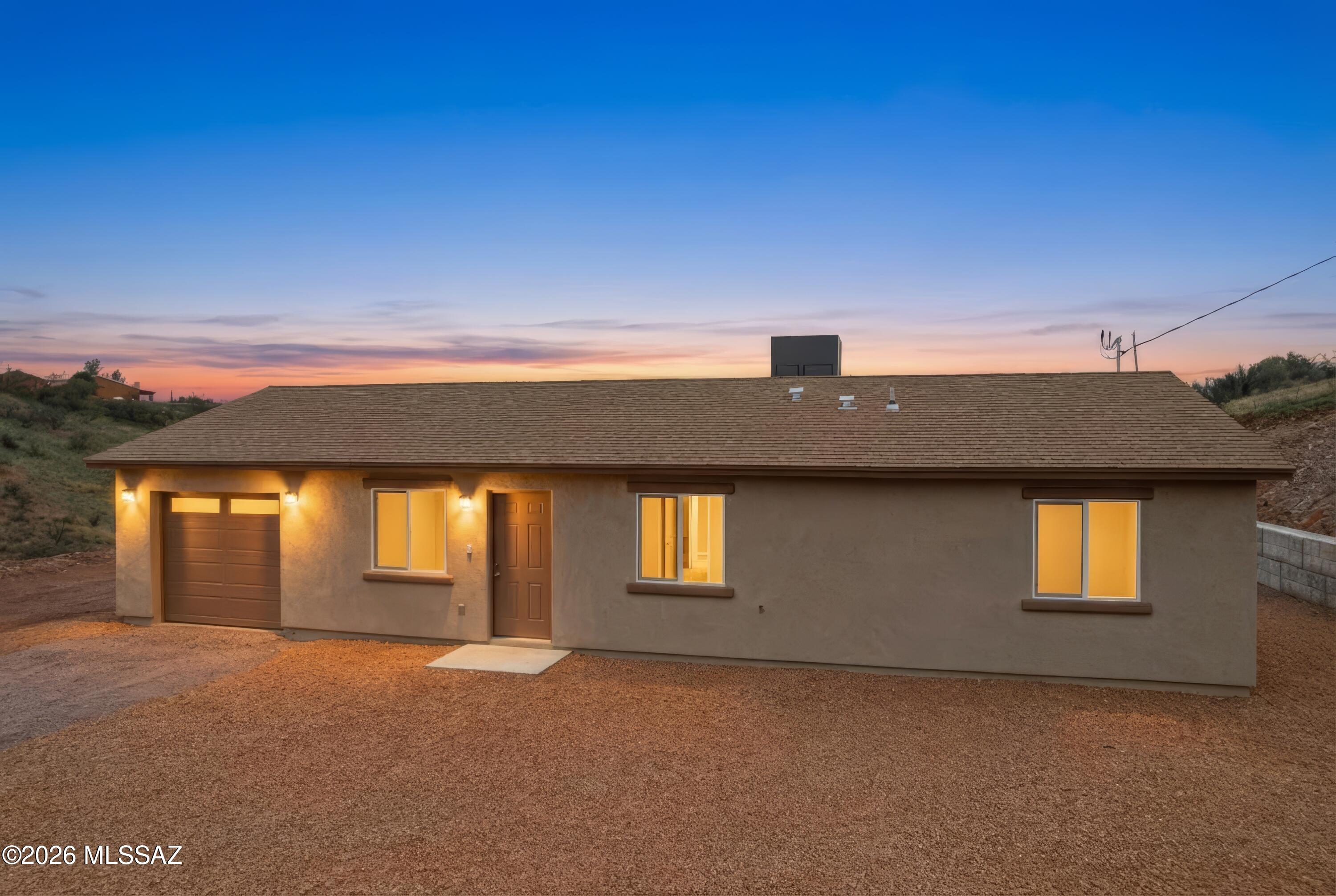 BRAND NEW CONSTRUCTION HOME QUALIFIES FOR USDA/0% down! Ask me for details!!  Welcome home! Beautiful turn-key ready home sits on over an acres with views! Come inside and walk this well laid out open floor plan including an open kitchen featuring new stainless-steel appliances and a neutral color palette. This home has 3 bedrooms, 2 bathrooms, 1 car garage, no HOA and located off a paved road. All bedrooms have a very spacious feel with tile throughout, and they also all have ceiling fans already installed. Sweeping mountain views from every direction. Home is located a few miles from I-19 making it a very easy commute to Tucson, Nogales and surrounding areas. Call me to schedule your showing today, Rio Rico still leads when it comes to affordable housing!