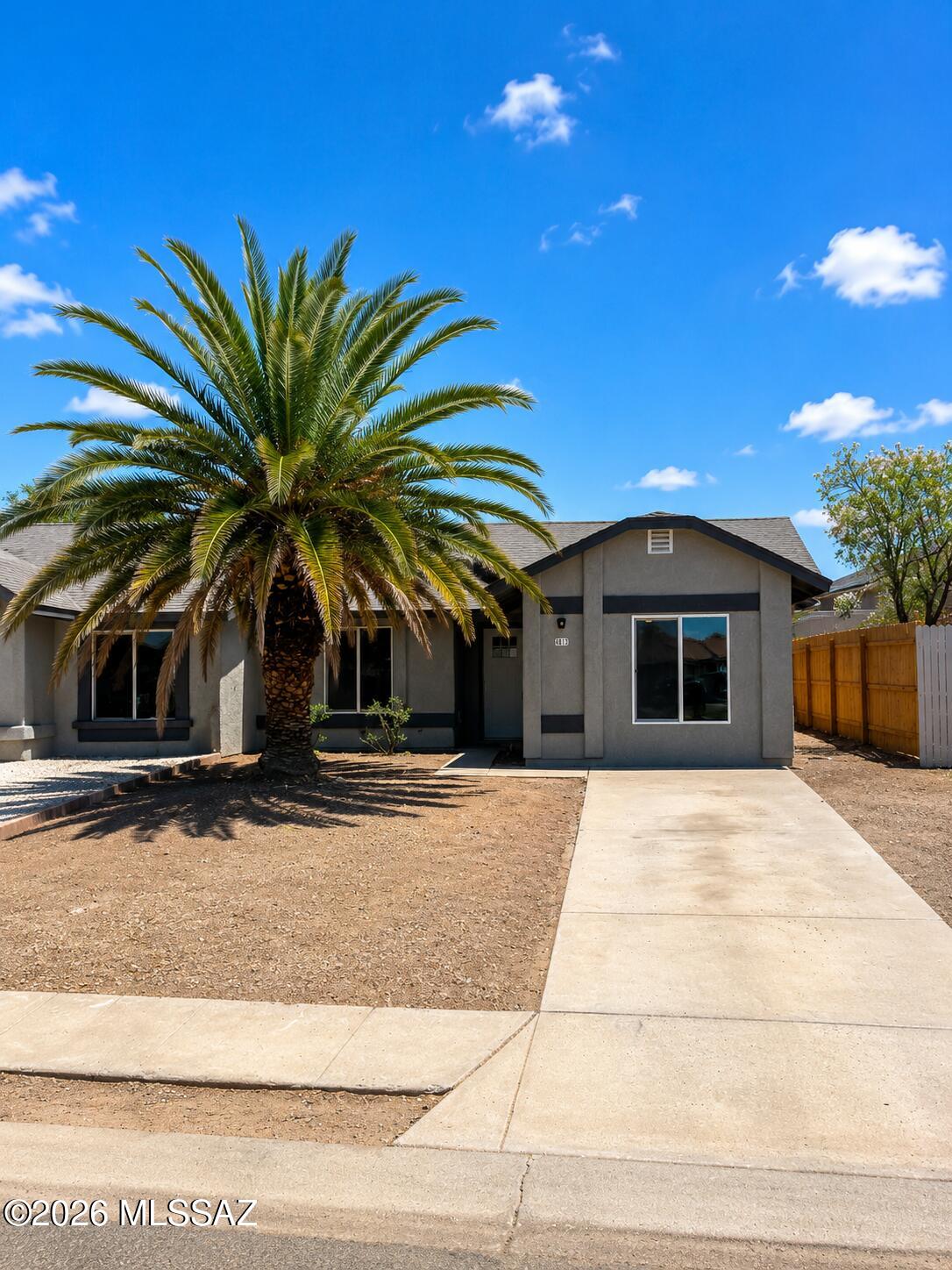 Beautifully renovated and move-in ready! This thoughtfully updated home features an open-concept floor plan with soaring vaulted ceilings, abundant natural light, and a fresh modern color palette throughout. The spacious living area flows seamlessly into the completely remodeled kitchen, showcasing new shaker-style cabinetry, granite countertops, stainless steel appliances, a large pantry cabinet, and durable tile flooring. The primary suite offers a beautifully remodeled bathroom with a custom tiled walk-in shower, modern vanity, and updated fixtures. Additional upgrades include luxury vinyl plank flooring in the main living areas, plush carpet in the bedrooms, contemporary ceiling fans and lighting, fresh interior and exterior paint, and updated doors and trim. OWNER/AGENT Outside, you'll find a low-maintenance front yard highlighted by a mature palm tree, an extended driveway, and a fenced backyard ready for your personal touch. Conveniently located near shopping, dining, schools, and Davis-Monthan Air Force Base, this home offers the perfect combination of style, comfort, and convenience.