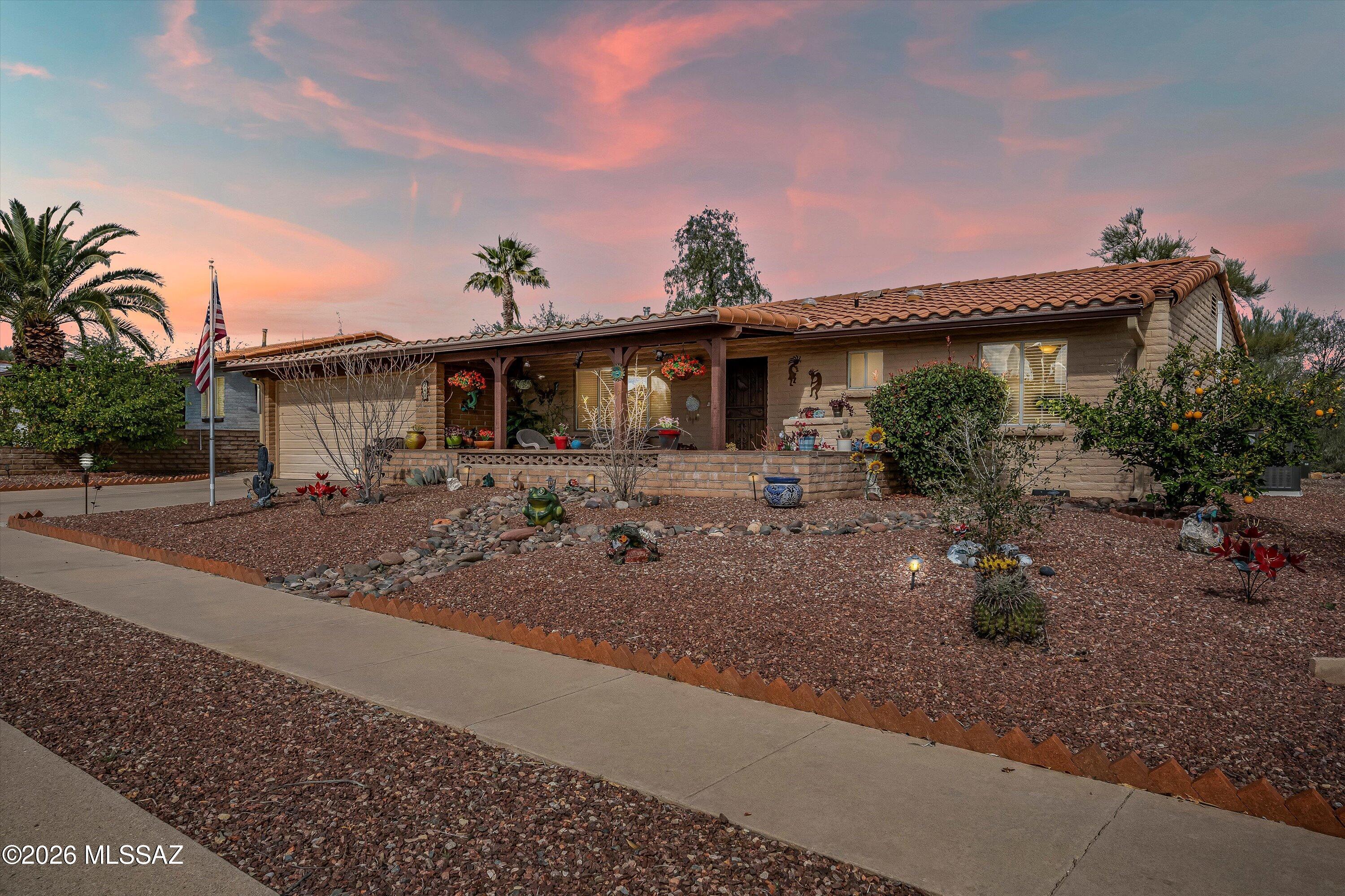 NO GVR(but avail), FULLY FURNISHED, Heated and cooled Arizona room,  OVERSIZED GARAGE, NEWER HVAC!

Nestled in the charming, character-filled Desert Meadows Neighborhood of Green Valley, this beautifully maintained, brick,  single-story home offers comfort, flexibility, and an inviting sense of community. There is no requirement to join Green Valley Recreation, though membership is available on a voluntary basis for those who wish to enjoy additional amenities--an appealing and relatively rare option in the area.
From the covered front porch, enjoy peaceful mountain views and the simple pleasure of morning coffee or evening relaxation while connecting with friendly neighbors. Just steps away, Desert Meadows Park enhances everyday living with The historic De Anza walking trail, native desert landscaping showcasing the area's diverse cacti and plant life, along with so much more- It's an ideal setting for leisurely walks, pet outings, and soaking in the beauty of the Sonoran Desert.
Inside, the home has been thoughtfully updated and freshly painted, creating a move-in-ready experience. The property is being sold fully furnished, making this an easy and convenient turnkey opportunity- simply bring your personal belongings and settle in. The kitchen features rich cabinetry paired with newer stainless steel appliances, offering both warmth and functionality.
A standout feature is the Arizona room, which is heated and cooled for year-round use and offers excellent flexibility for entertaining, hobbies, or relaxing in comfort.
The backyard is spacious, private, and low maintenance perfect for pets, outdoor gatherings, barbecuing, or quiet moments of relaxation. Practical upgrades include a newer HVAC system and a tankless water heater. The extended two-car garage offers impressive versatility, comfortably accommodating a tall truck and an additional vehicle while still allowing for generous storage. The laundry area is conveniently located inside the garage, and an additional outdoor parking space at the rear of the home is ideal for a trailer, boat, or extra recreational toys.
Surrounded by golf courses and set within one of Green Valley's most endearing neighborhoods, this Desert Meadows home offers a relaxed, convenient lifestyle with the freedom to enjoy the area at your own pace. Whether you're seeking a full-time residence or a seasonal retreat, this home delivers comfort, character, and true move-in ease.