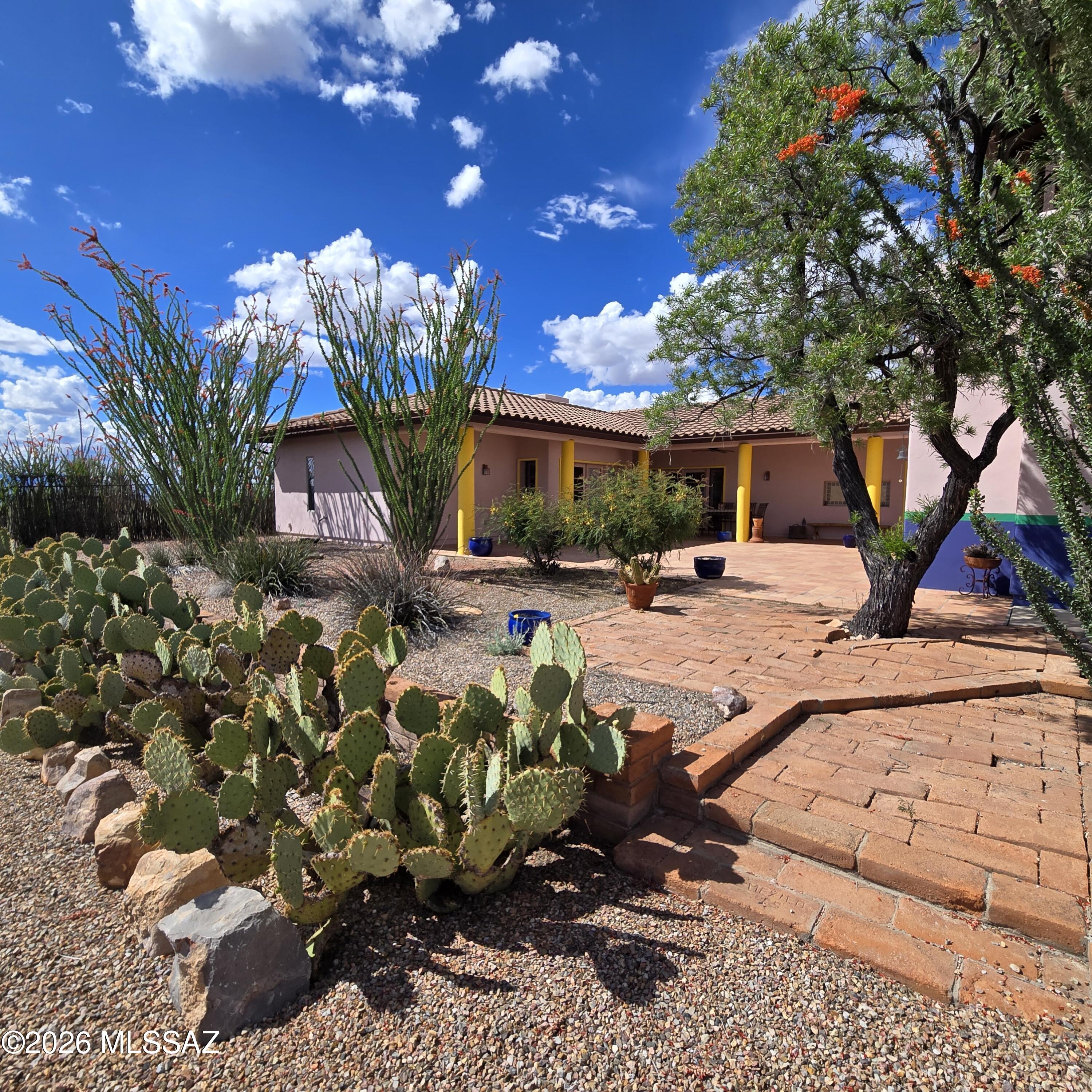 Tucked away in a serene and private setting in the outskirts of Bisbee, this exceptional Southwestern-style estate offers space, flexibility, and breathtaking 360° mountain views across 37+ acres. Designed with both comfort and creativity in mind, the property features a main residence, a combined guesthouse and art studio, plus a detached garage with a separate office--ideal for multi-generational living, remote work, or income potential.
The main home showcases quality construction with 2x12 framing and 13-inch-thick walls, complemented by classic stucco exterior and a durable tile roof. Inside, you'll find 9-foot ceilings, Saltillo tile flooring, built-in bookcases, wall niches, and tiled window ledges that add warmth and character throughout. The living space is anchored by a charmin Talavera tile fireplace, while four sets of French doors open to an expansive, partially covered tiled patio--perfect for enjoying the surrounding landscape.
The kitchen blends functionality and style with Talavera tile countertops, custom knotty alder cabinetry, pull-out drawers, a gas cooktop with downdraft, wall oven (conventional/convection) , and breakfast bar. A formal dining room adds to the home's livability, while large bedrooms, generous closets, and custom doors enhance the overall design.
The primary suite offers a spa-like experience with a walk-in shower, Talavera tile finishes, and custom cabinetry. Additional bathrooms feature thoughtful details including tiled counters, custom toilet niches, and grab bars.
Comfort is ensured year-round with central A/C, ceiling fans, and two HVAC systems (one replaced in 2019, the second recently serviced in 2025).
The guesthouse/art studio, built in 2005, spans approximately 1,300 sq. ft. and features 10-foot ceilings with exposed beams, central A/C, 1 HVAC system, propane heating, a large walk-in shower, half bath, washer/dryer, and a kitchenette setup with stove, refrigerator, microwave, and additional mini-fridge in the studio area. Skylights bring in abundant natural light, making this an ideal creative or guest space.
Additional improvements include a detached two-car garage with an office above (with exterior access), three additional parking spaces, private well with owned water softener, APS electric, and two septic systems serving the property.
The acreage is both functional and picturesque, with barbed wire perimeter fencing and a separately fenced inner area. Whether you're seeking a private retreat, artist compound, or versatile homestead, this one-of-a-kind Bisbee property delivers space, privacy, and endless potential.  Priced Below Appraised Value!