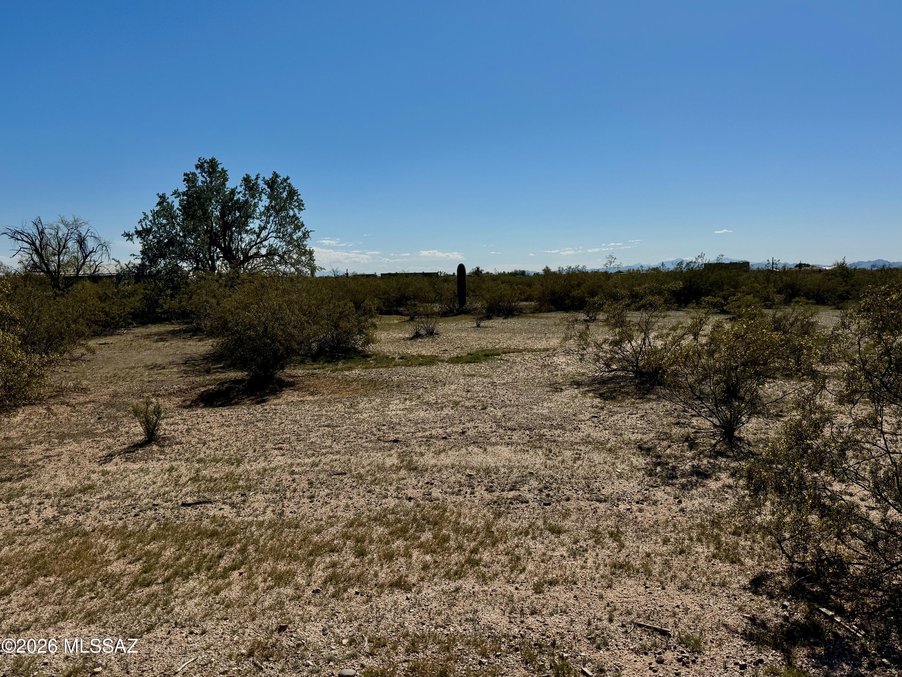 Embrace the ultimate Arizona homestead dream with this pristine 12-acre parcel in Marana, perfectly primed for a custom ranch or luxury estate. Offering privacy, the eastern boundary directly borders protected State Land, featuring a stunning natural wash and breathtaking, unobstructed desert views. The acreage is rich with mature native vegetation, including majestic saguaros. With multiple flat, ready-to-build sites spread throughout the topography, designing your custom build has never been easier. Infrastructure & Logistics Ready: Utilities: Electric, telephone, and water are already conveniently located at the lot line. Water Supply includes a reliable well share with 12 on the cooperative. 
Lot can be split 4 times! Calling all developers! Tested & Approved: A newly split lot from this parcel just passed its conventional perc test. Neighbors' tests have successfully passed as well. Bring your horses and your architect--this exceptional horse-zoned property allows for site-built custom homes only (no manufactured homes). Build the serene desert lifestyle you have always envisioned.