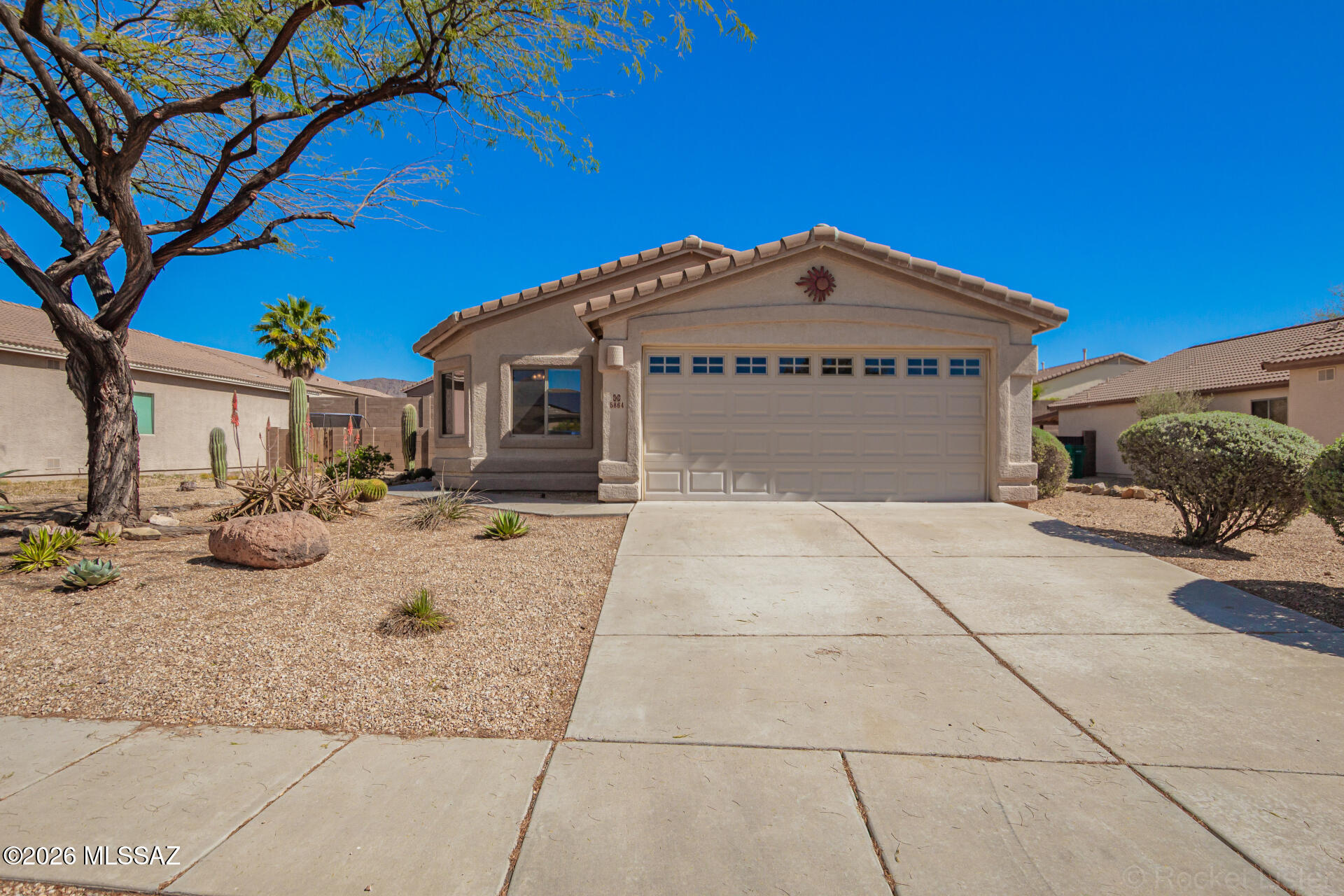 Nestled at the base of the majestic Tucson Mountains, the beautiful Tucson Mountain Sanctuary subdivision offers walking trails and parks. Featuring an extended, wrap around patio that serves as a second living room allowing you to enjoy ample outdoor time in the shade. This four-bedroom, two-bath home has had the HVAC replaced and the roof underlayment done.   Relax in the spacious owner's suite, which features a walk-in closet and an en suite with a soaking tub and shower. Elegant tile flooring flows throughout the home, complementing the open-concept kitchen, which features granite countertops, stainless steel appliances, a breakfast bar, and a welcoming dining area. The versatile fourth bedroom, highlighted by double doors, is ideal for a home office, den, or hobby or or game room.  Conveniently located near Tucson Mountain Park, this home offers easy access to scenic hiking and biking trails, as well as freeway access, providing the perfect balance of comfort, style, and location.