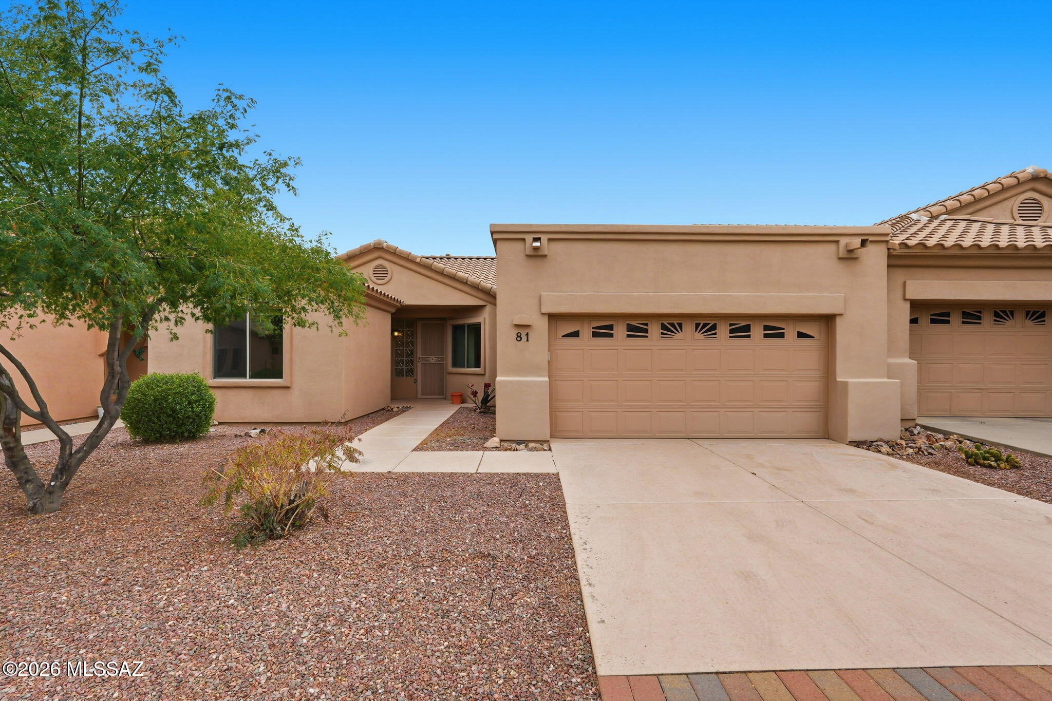 Spectacular 2BD/2BA +Den townhome in gated Vistoso Village active adult community boasts resort style amenities and energy efficient solar. Amenities include clubhouse, fitness center, billiards room, library, pool, spa and lap pool. HOA fees include water, trash, basic cable, front/rear landscaping, roof, exterior pest control and more! This larger model with 2 car garage features an open concept, split bedroom plan, vaulted ceilings plus updated kitchen, baths and plank flooring. Sleek chef's kitchen hosts stainless Bosch appliances, breakfast nook & bar plus adjacent laundry room. Primary suite offers a luxury bath with extended dual sink vanity, sleek tiled walk-in shower and updated walk-in closet. Relax on the rear patio with wrought iron fence, raised privacy wall and mature trees beyond. A truly outstanding opportunity within a highly desirable community.
