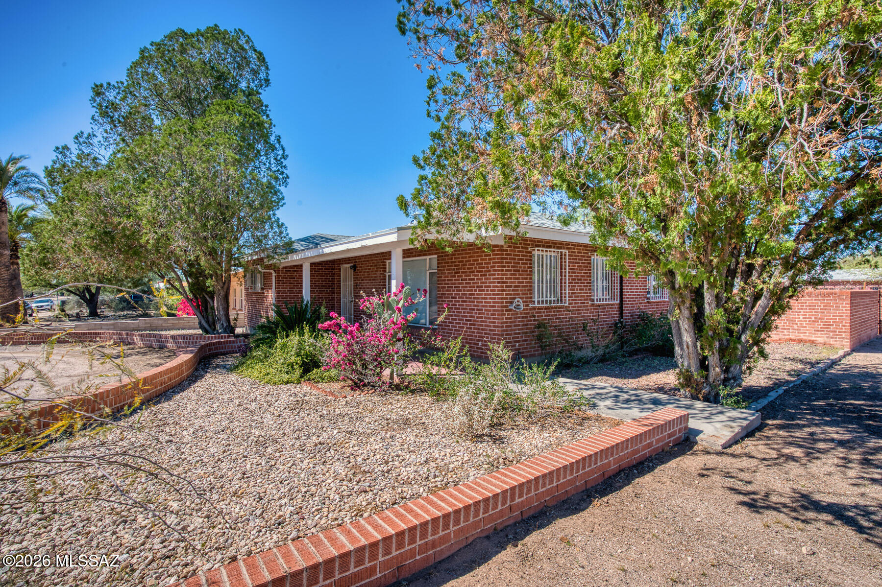 $5,000 towards buyer's closing costs however they choose to use with approved offer! Poets Square Charmer- Fully Updated & Move-In Ready! Solid brick mid-century bungalow featuring a new kitchen, updated bathroom, and brand-new white oak luxury vinyl flooring throughout. Major upgrade includes new plumbing in the kitchen and bath replacing original cast iron. Previous owner updated HVAC & Roof. Situated on a spacious .2-acre corner lot with abundant parking and a beautifully landscaped walled backyard complete with a private putting green. Includes 2 bed / 1 bath in the main house plus a second bathroom in the garage with expansion potential. Prime central location near shopping, U of A, dining, and everyday conveniences.
