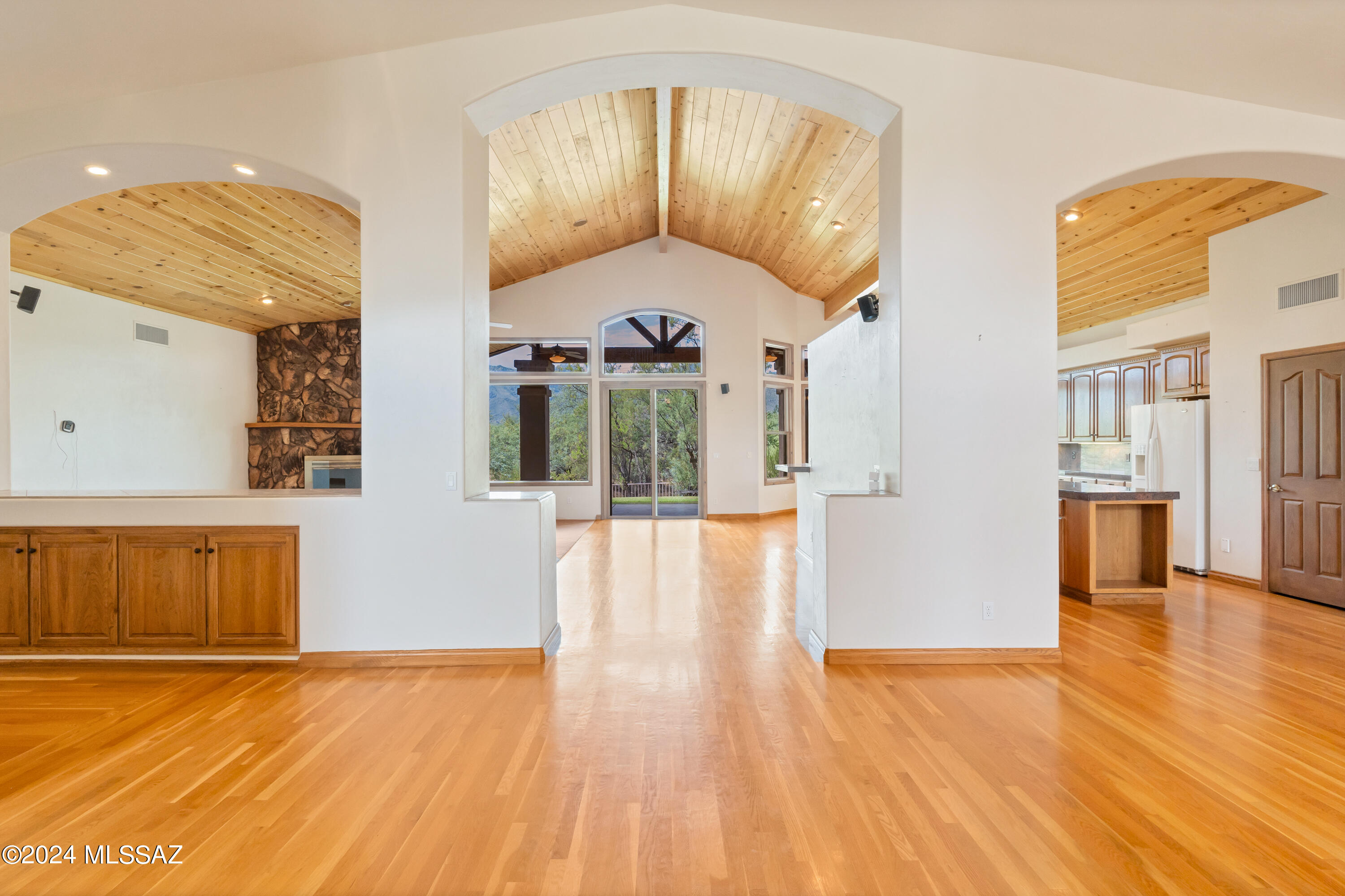 Perfectly executed custom home strategically placed on this secluded and lush 4+ acre lot takes every advantage of panoramic views to Thimble Peak, Sabino Canyon& Catalina Mtns.  The 500 foot drive affords privacy but you're just minutes from city amenities & restaurants.  Adjacent to McDonald Park with nature walking paths, dog parks and multiple facilities.  Be welcomed home with cathedral wood ceilings, floor to ceiling windows and an open floor plan.  The expansive gourmet kitchen opens to the great room and offers views of the backyard, mtns, desert fauna.  Kitchen also offers center island, custom wood cabinets wrapping the kitchen area for plenty of storage, plus a large walk-in pantry.  The master suite is ultra private-bath has jetted tub and walk-in shower, large walk-in closet.