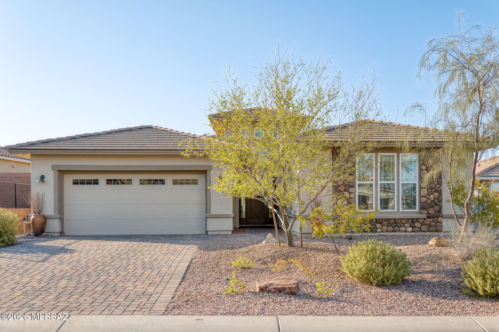 RANGE PRICED - Seller will accept or counter offers between $560,000 and $575,000. Sellers are offering $5,000 in concessions to be applied toward the buyers' closing costs and/or interest rate buy-down.  Step into unrivaled desert luxury at Dove Mountain! Discover the essence of relaxed living in this exquisite Prairie-style home, nestled within the gated community of Golden Barrel Place. Spanning a generous 2,312 square feet, this airy residence isn't just a house; it's a sanctuary designed for the ultimate Tucson lifestyle. Spacious interiors greet you from the moment you step into the welcoming foyer, leading you to an expansive Great Room for easy entertaining. The split floor plan separates the bedrooms, with a serene primary suite boasting tile flooring and a spa-like en-suite bathroom with dual shower heads. Two additional bedrooms share a convenient Jack and Jill bathroom, complete with double sinks, perfect for family or guests.
The heart of this home is undoubtedly the gourmet kitchen, a culinary dream featuring a large island, a built-in gas cooktop, a wall oven and microwave combination, a charming breakfast nook, and a spacious walk-in pantry. For added convenience, a LifeSource whole-house water filtration system produces purified water.  The laundry room comes equipped with a washer, dryer, and an extra refrigerator - all appliances convey!
Outside, your private oasis awaits. The backyard offers a perfect blend of low-maintenance luxury with a covered patio, pavers, and artificial turf, all enclosed by a block wall with iron accents.
Beyond your doorstep, an active, luxurious lifestyle beckons. You're just moments from the renowned Ritz-Carlton, The Gallery Golf Club, and The Golf Club at Dove Mountain. This exceptional home is move-in ready, awaiting your personal touch to begin your desert dream.