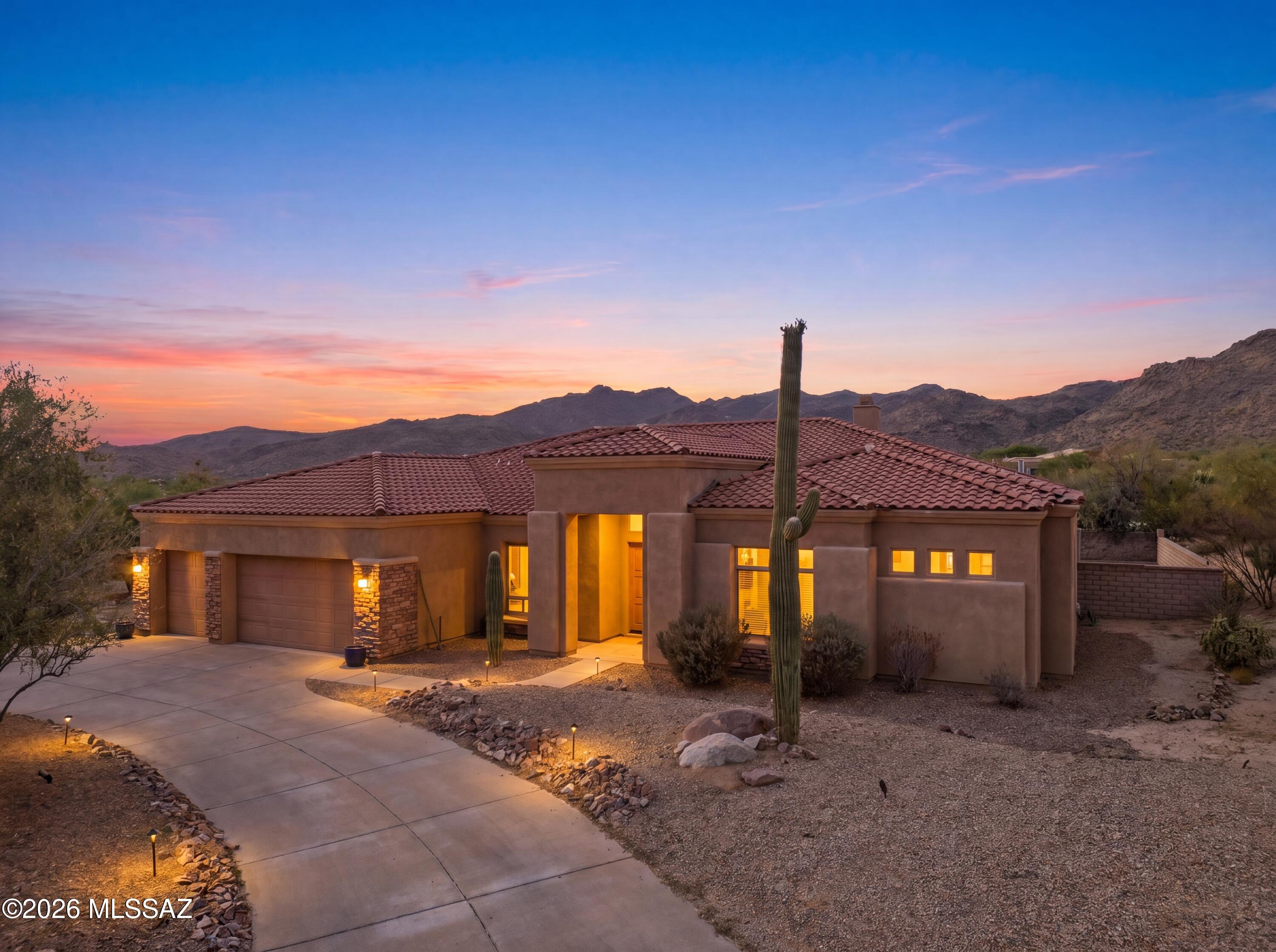 Nestled on nearly an acre within the prestigious gated community of Dos Lagos, this exceptional 3-bedroom, 3-bath residence with a private den offers over 3,000 square feet of refined desert living surrounded by the breathtaking beauty of the Tortolita Mountains. Designed to impress, the expansive great room features soaring ceilings, a dramatic fireplace, and walls of windows that frame stunning mountain vistas while filling the home with natural light. The chef-inspired kitchen showcases beautiful natural leathered marble countertops, rich finishes, and an effortless connection to the main living and entertaining spaces. Elegant travertine flooring flows throughout the home, adding warmth and timeless sophistication. Step outside to a true resort-style backyard designed for entertaining and relaxation. Enjoy the generous pool and spa, elevated sunning platform, lush turf areas, and multiple outdoor living spaces, all set against a backdrop of spectacular mountain views and serene desert surroundings. The covered patio provides the perfect place to enjoy Arizona's year-round outdoor lifestyle.

Situated on a desirable corner lot in one of Dove Mountain's most sought-after neighborhoods, this home offers exceptional privacy, tranquility, and convenient proximity to The Golf Club at Dove Mountain, The Ritz Carlton, and the area's renowned golf, dining, and recreational amenities. Completing the property is a spacious 3-car garage and the rare combination of luxury, space, and an incredibly peaceful setting.

Experience the very best of Dove Mountain living.