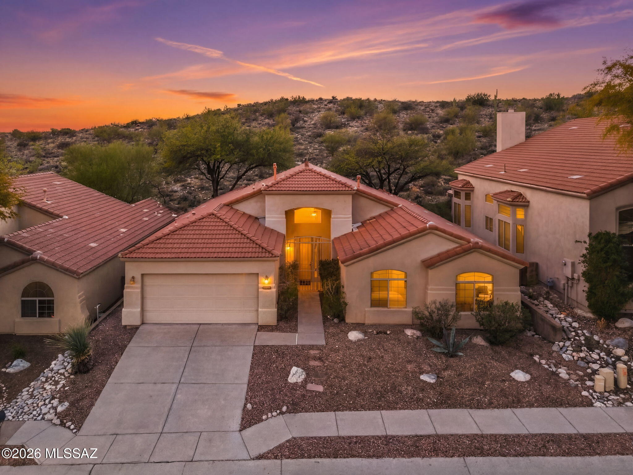 ASSUMABLE FHA LOAN AT 2.375% (must qualify). Welcome to the highly sought-after gated community of Sabino Mountain in North Tucson, where privacy, natural desert beauty, and stunning views come together. This well-maintained 4-bedroom, 2-bath home is perfectly positioned to enjoy natural desert views in both the front and rear, offering opportunities to see local wildlife, while the front yard also captures beautiful city views. The flexible floorplan includes both a living room with dining area and a separate family room, along with an eat-in breakfast nook just off the kitchen. The kitchen is designed for both style and function with stainless steel appliances, a 5-burner gas range, Quartz countertops, custom tiled backsplash, and a center island with seating and pendant lighting. 

The spacious primary suite includes a sliding glass door that opens to the backyard patio, creating a peaceful retreat with easy access to outdoor living. The primary bathroom features dual sinks, a separate shower, and a relaxing soaker tub with custom tile surround. 

The home features granite countertops in the hall bathroom, wood-look tile throughout, soaring vaulted ceilings, ceiling fans, and faux wood blinds for a clean, modern feel. 

Recent updates include new fixtures, hardware, refrigerator, washer, kitchen and bathroom sinks (2023-2024), a 2024 water heater, and one HVAC unit replaced in 2020, providing added value and peace of mind (seller is open to offering a credit toward a new HVAC unit (2nd unit) with an accepted offer.) The garage is also equipped with an electric vehicle charging outlet, adding modern convenience. 

The backyard is ideal for enjoying Tucson's beautiful desert setting with an extended covered patio featuring a metal roof and pavers, perfect for relaxing or entertaining. Residents of Sabino Mountain enjoy a gated community with a pool, spa and clubhouse, all surrounded by the spectacular Sonoran Desert landscape while remaining close to North Tucson amenities. 

This home comes with a below-market assumable FHA loan at just 2.375%--a rate that's virtually impossible to find in today's market. This is the equivalent of getting a massive price reduction without negotiating the price. Opportunities like this are extremely limited--