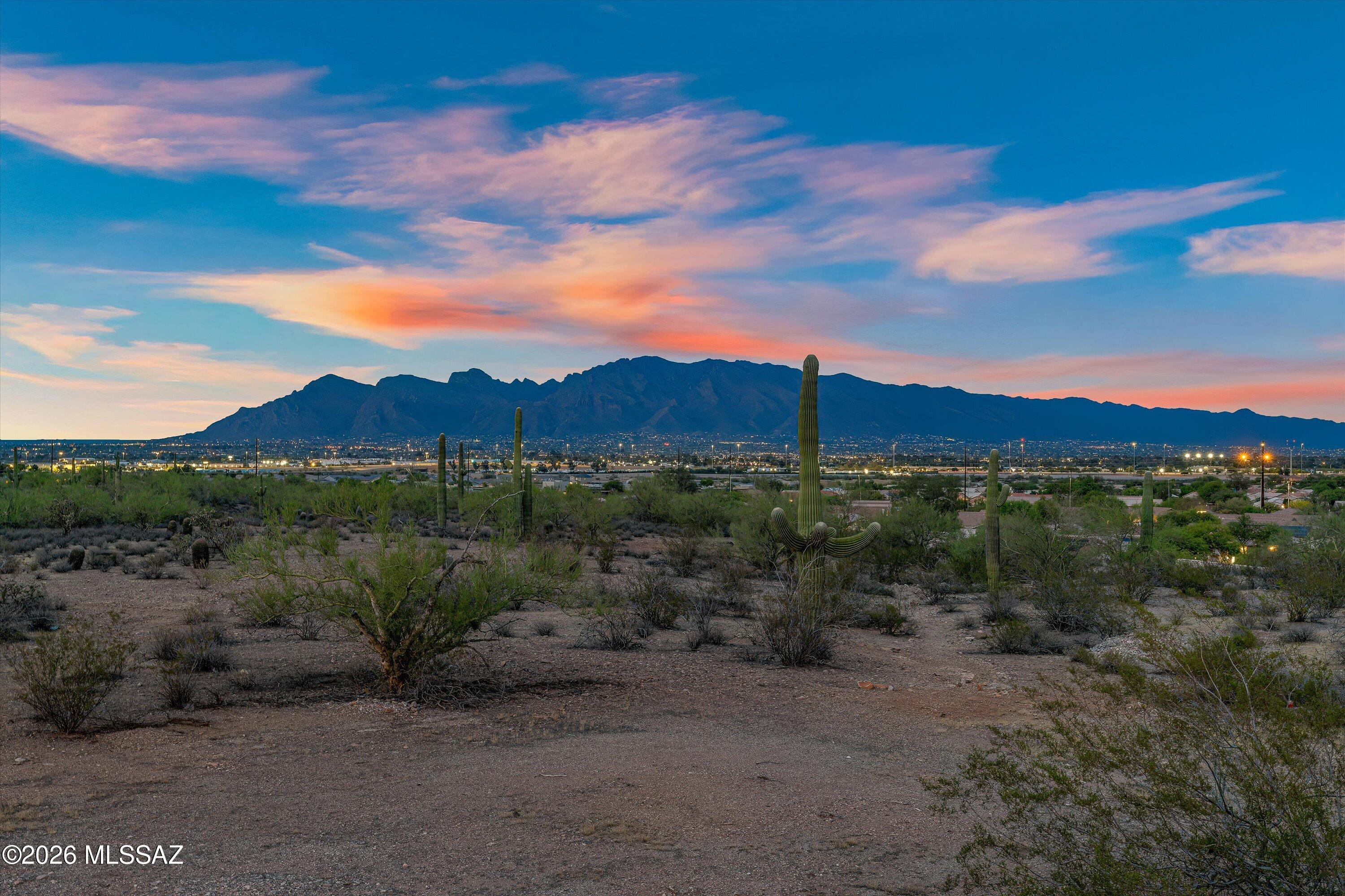 **Range Priced: Sellers will accept/counter offers between $999,999-$1,295,000** Wake up each day to the beauty of exceptional desert living in this stunning 3-bedroom/3-bath custom home where every square inch has been meticulously designed with comfort, style, & functionality in mind. Perfectly positioned to capture breathtaking views of all 4 surrounding mountain ranges - Catalinas, Rincons, Santa Ritas, & Tucson Mountains - this immaculately maintained home offers a seamless blend of modern elegance & natural beauty.
The impressive split-bedroom floor plan provides privacy & flexibility, while concrete floors throughout create a sophisticated, contemporary aesthetic. At the center of the home you'll find a chef's kitchen purposefully created to impress, featuring high-end finishes, generous workspace, & an ideal layout for entertaining. Masterfully designed to embrace Tucson's indoor/outdoor lifestyle, this exquisite property offers more than 2,000 sq ft of covered outdoor living space, creating the perfect setting for entertaining, relaxing, & enjoying the gorgeous desert scenery. Step outside to your private backyard retreat, where a heated 40-foot pool invites year-round enjoyment against a backdrop of spectacular views. Adjacent to a nature preserve, the property offers a rare sense of tranquility, privacy, & connection to the surrounding landscape.
Additional highlights include two laundry rooms, spacious living areas filled with abundant natural light, & extraordinary attention to detail throughout. The spacious 3-car garage is equipped with two EV fast chargers, while ample additional outdoor parking provides plenty of room for guests, recreational vehicles, & outdoor toys--so bring the RV. Located just minutes from downtown & I-10, this remarkable home combines luxury, convenience, & unparalleled desert views in one unforgettable package.
