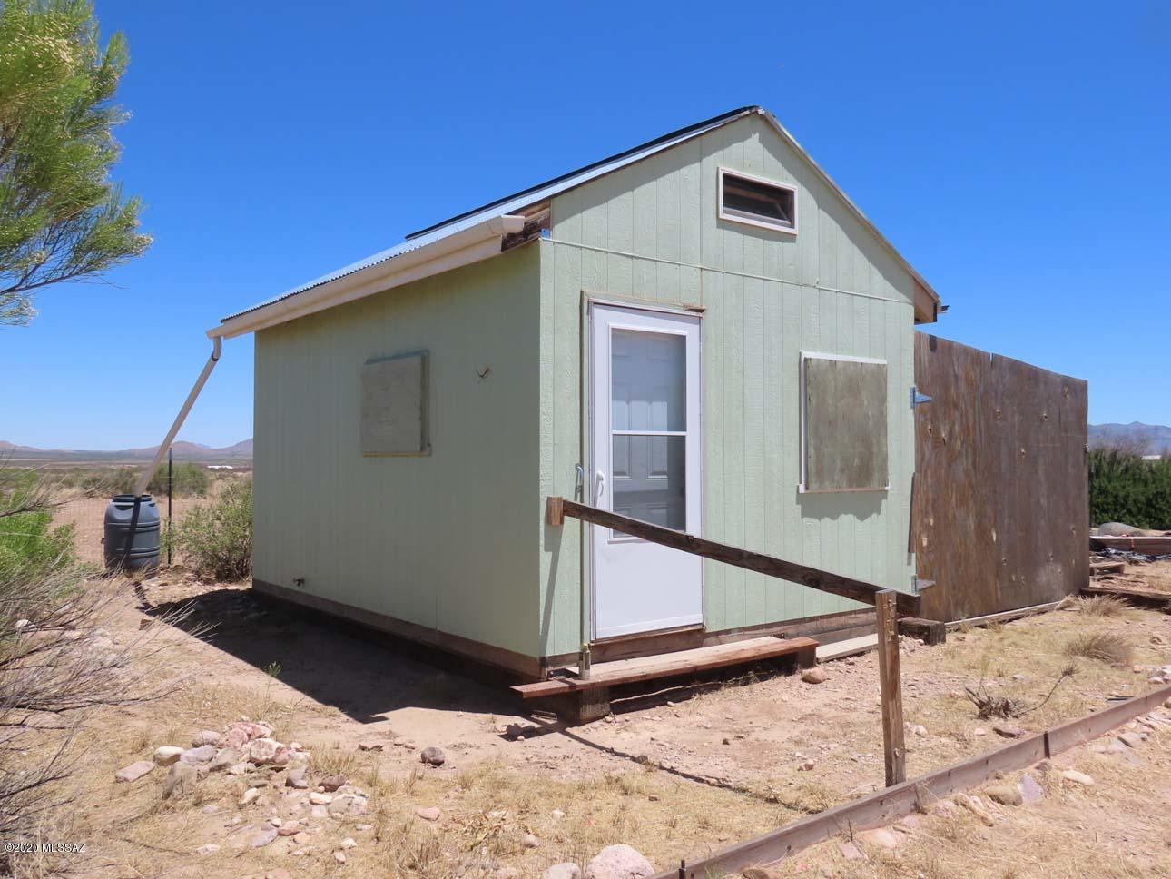 Twenty acres, ready to install manufactured or build! Dark skies! No HOA, no deed restrictions. Good well, septic, electric, & a 12 X 16 house with bathroom and kitchen corner, live in while you build. Water heater needs hooking up, RV hookup. Fruit & shade trees on drip, fenced area for dogs, soil is great for gardening. You can see clear to the 10,000' Pinaleno mts, watch the stars rise in the east. Major shopping: 70 mi to Douglas AZ, 90 to Silver City NM, Safford AZ, 145 to Tucson airport. Verizon & ATT, Portal has medical clinic, EMS, VFD, library, also local post offices, cafes, convenience stores;  hardware & gas in Animas & San Simon. Great birding, wildlife viewing, hiking, in cool canyons and high conifer forests of Chiricahuas. Neighbors cooperate to maintain dirt roads