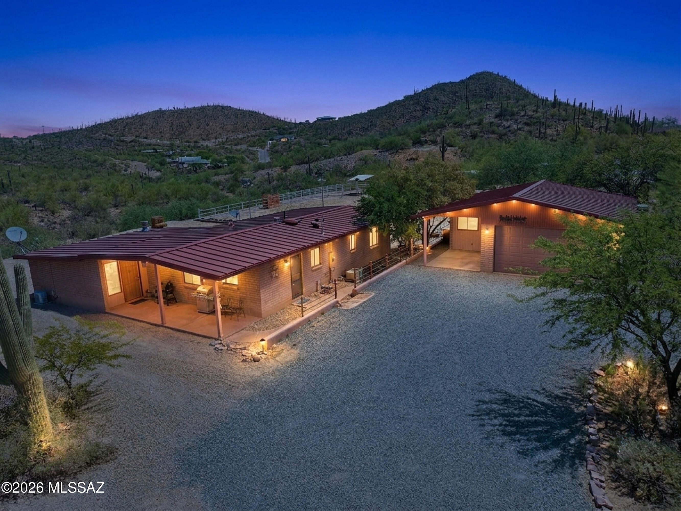 Rare opportunity to own a 1.25-acre horse property backing directly to Tucson Mountain Park with breathtaking mountain and desert views and access to 60 miles of scenic equestrian riding trails, hiking, and biking. This well-maintained 3-bedroom, 2-bathroom home offers a comfortable floor plan, spacious kitchen with extra cabinets and Corian counters, a metal roof, a large 2-car garage, and a covered patio perfect for enjoying Arizona's spectacular sunsets. Horse amenities include 4 stalls, a riding arena, a hay barn, and ample space for your animals and equipment. Enjoy the privacy, peace, and outdoor lifestyle this unique property offers while still being conveniently located 5 minutes away from shopping, dining, and everyday amenities. A rare combination of location, views, and equestrian amenities! Schedule your showing today and don't miss this opportunity.