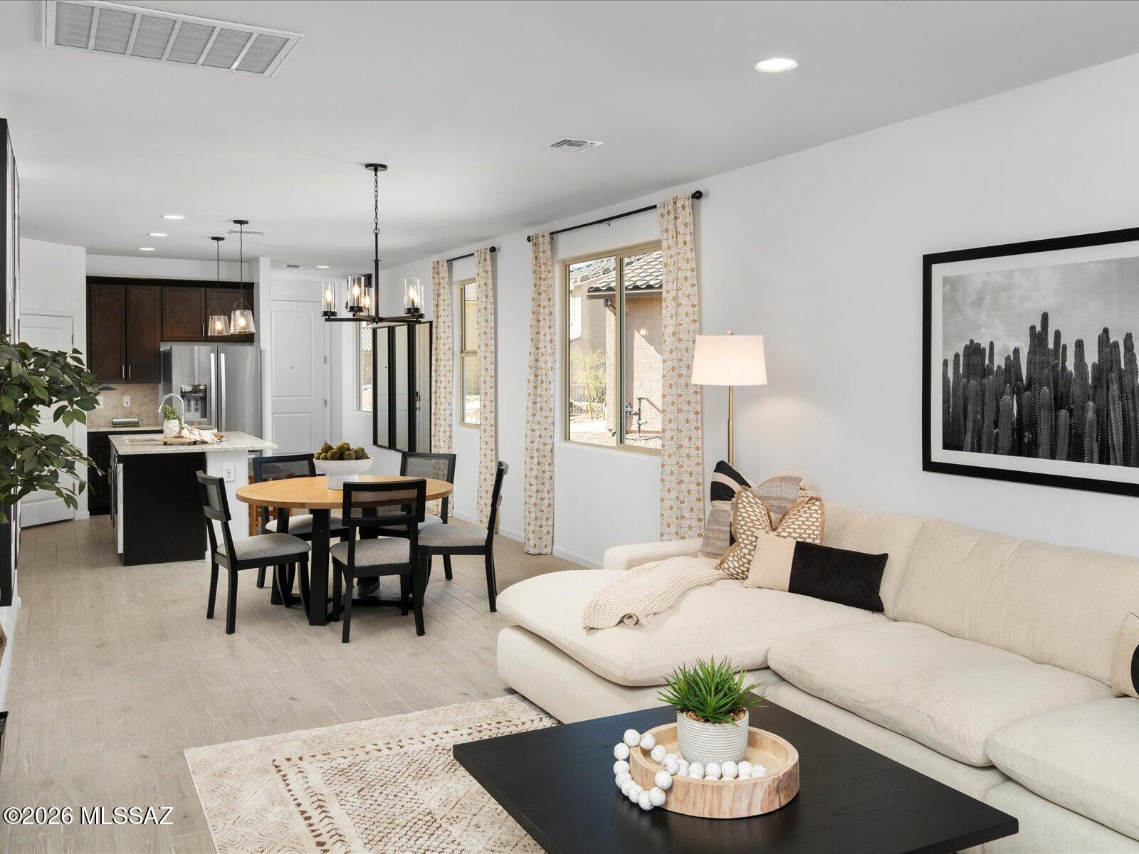 3-bedroom, 2-bath home offering open-concept living and everyday comfort! Enjoy a spacious great room that flows seamlessly to a covered patio, perfect for relaxing or entertaining. Thoughtful storage abounds with a kitchen pantry, linen closets, and coat storage. Located in Las Patrias at Star Valley Phase III - Signature Series in Tucson, AZ, this community is less than 10 minutes from I-10, providing easy access to downtown Tucson and major employment centers. Residents enjoy walking and biking trails, playgrounds, and more. Move right in with a washer, dryer, refrigerator, and whole-home blinds included. Built with innovative, energy-efficient features designed to help you save while you live comfortably.