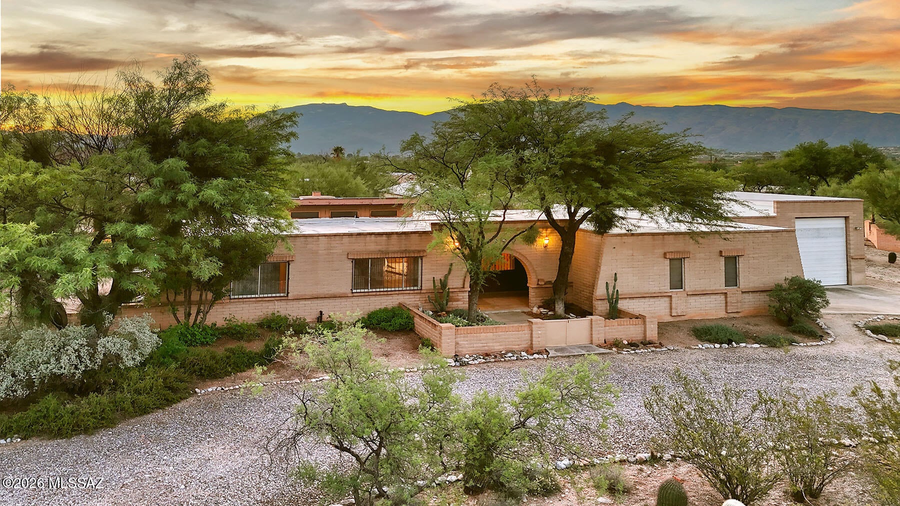 A Tanque Verde Valley Gem with Space, Privacy & Endless Possibilities!  In the heart of the sought-after Tanque Verde Valley, within Tanque Verde Vista, is this well-maintained 4-bedroom, 2½-bath all-masonry home situated on an expansive .99-acre lot. Offering 2,513 square feet of living space, the home is well-cared-for, yet provides a wonderful opportunity to add your own personal touches and create the home you've envisioned.  The inviting floor plan features a comfortable living room and a spacious kitchen/great room designed for everyday living and entertaining. The kitchen offers generous cabinetry, tile and carpet flooring, a beamed ceiling, and a charming used-brick fireplace that adds warmth and character to the space.  For the hobbyist, car enthusiast, or entrepreneur, the property truly sets itself apart. Attached to the home is a 2-car, 515-square-foot garage, followed by an impressive 1,095-square-foot RV garage and workshop complete with cabinets and shelving. This versatile space provides room for multiple vehicles, an RV, workshop, studio, home occupation, storage, and virtually any special interest you may have.  Step outside and discover a private backyard retreat with an expansive covered outdoor living area featuring brick paver flooring, mature trees, lush desert plantings, meandering walkways, and two koi ponds. A true gardener's dream awaits with the professional 18' x 34' greenhouse, complete with raised planting bed . . . perfect for growing flowers, vegetables, herbs, and more in a protected environment.  If you're searching for a home that offers space, privacy, versatility, abundant storage, room for your vehicles and hobbies, and an exceptional gardening opportunity, this Tanque Verde Valley property deserves a closer look. It's a wonderful blank canvas, ready for your vision, upgrades, and finishing touches to make it truly your own.