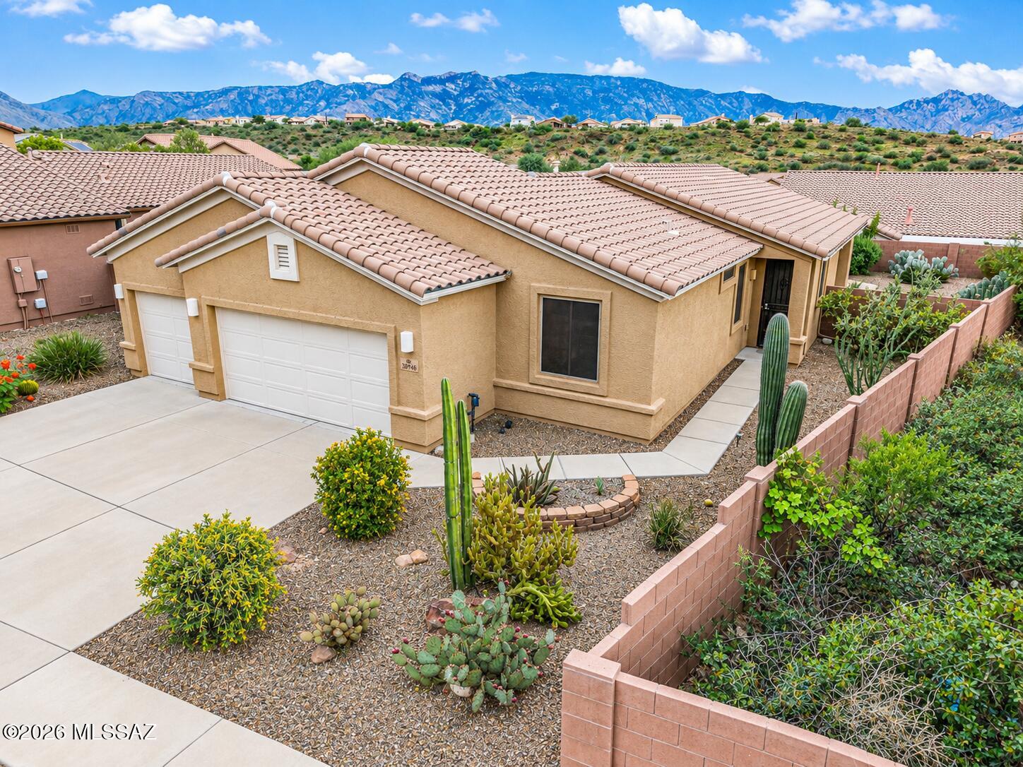 Enjoy stunning Catalina Mountain views from this beautifully updated one story home in desirable Eagle Crest Ranch! Fabulous floorplan featuring 3 bedrooms plus den and 2 full bathrooms. New flooring & freshly painted interior in bedrooms.  3-car garage provides overhead storage and a built in whole-house filtration system. Large backyard offers a covered patio and prewiring for hot tub with slab. Professional landscaping completed in 2024. The kitchen features newer LG appliances, including an InstaView refrigerator, electric range, dishwasher & microwave. Exterior paint, solar screens, and HVAC 2025. Conveniently located near Oracle and Catalina State Parks, schools, restaurants & shopping. Come discover your best life at Eagle Crest Ranch! Upgrades & Features in MLS Document
