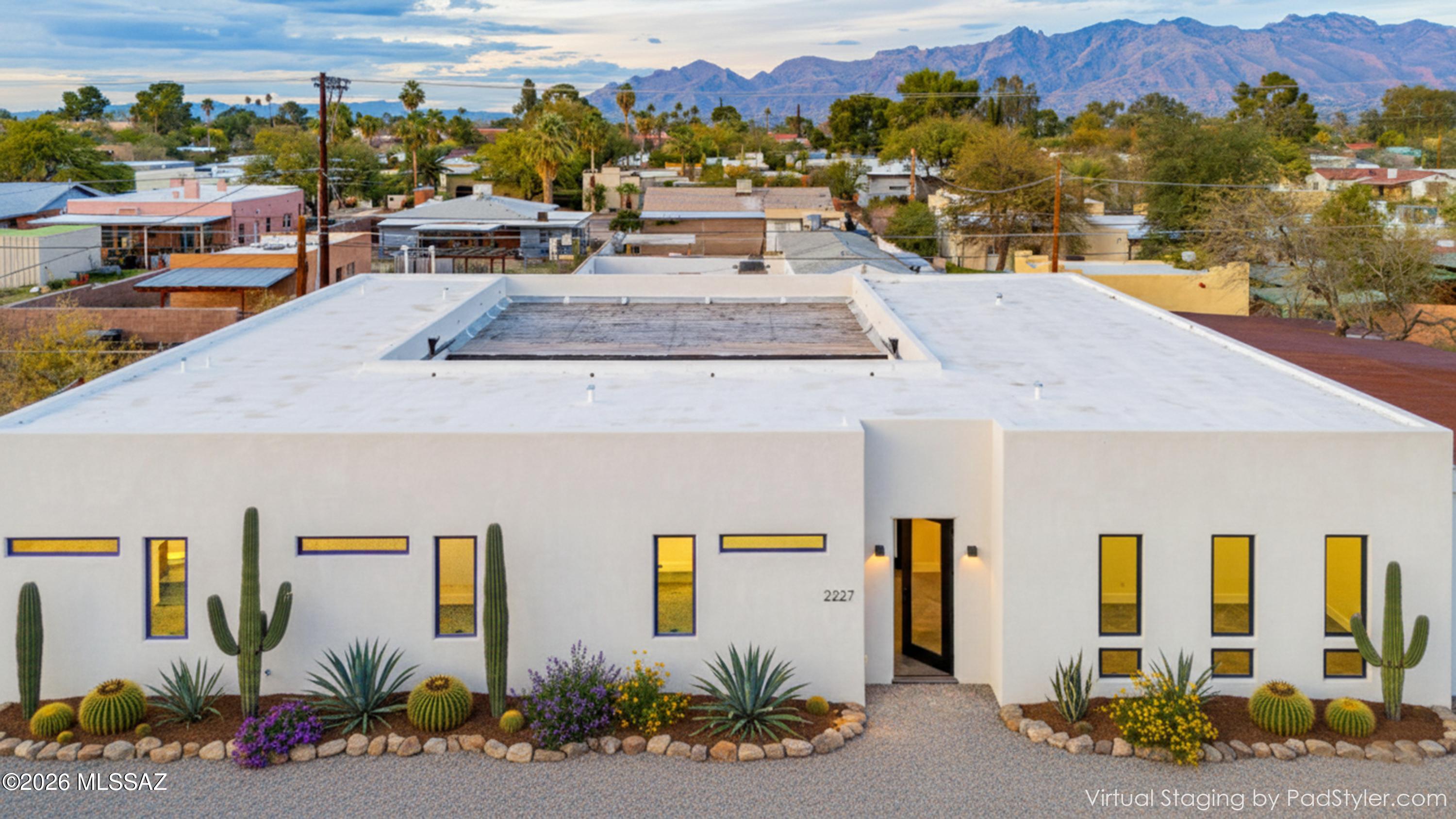 Ultra Contemporary Home near the U of A. High end quality Construction with Perfect Block construction. This home sits on a large .24 acre lot with 3005 square feet of living space. Main home is 4 bedrooms plus den with 3 1/2 baths and guest house with separate entrance on east side of home with 2 bedroom/ 1 bath. Unique floor plan with interior Atrium for exceptional peace and quiet, perfect for entertaining. Large great room that opens onto a Custom Gourmet kitchen with walnut cabinetry and Thermador appliances. Plus a large island with custom concrete counter tops with waterfall edges. Master Suite has custom designed furniture that remains with the home. Attached contemporary bathroom with separate and shower & custom designed walk in closet plus the master has its own separate patio. Guest house was rented for $1600 per month but currently vacant. The atrium off of the great has folding glass doors that open onto the atrium. Plus access to the atrium off of the master bedroom. Plus the master bedroom has its own private yard on the west side of the home. Main house is 2378 square feet with 627 square feet in the guest house.
