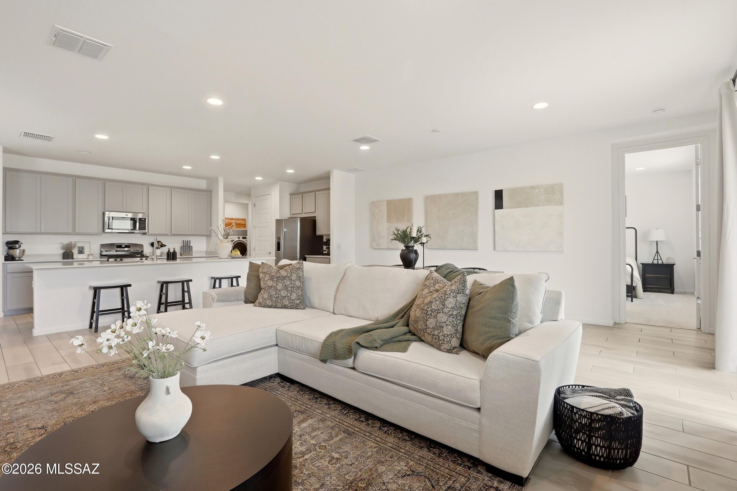 Stunning single-story home featuring a thoughtfully designed layout and modern upgrades throughout. The split floor plan offers privacy for all bedrooms, while 9' ceilings and plank tile flooring in the main living areas create a bright, open feel.

The kitchen is beautifully appointed with upgraded cabinetry, pull-out shelves, quartz countertops, and ample space for both everyday living and entertaining. Energy-efficient features include a tankless water heater, whole-home water softener, reverse osmosis system, smart thermostat, and a TAEXX built-in pest control system. Step outside to a spacious, landscaped backyard complete with turf, pavers, and a covered patio--perfect for relaxing or hosting guests. The 2-car garage includes an EV charging port, adding convenience for modern living.

Located in the desirable La Estancia, a master-planned community in the Vail School District. Residents enjoy access to parks, playgrounds, two community pools, a splash pad, The Loop, and quick access to some of Tucson's top employers.