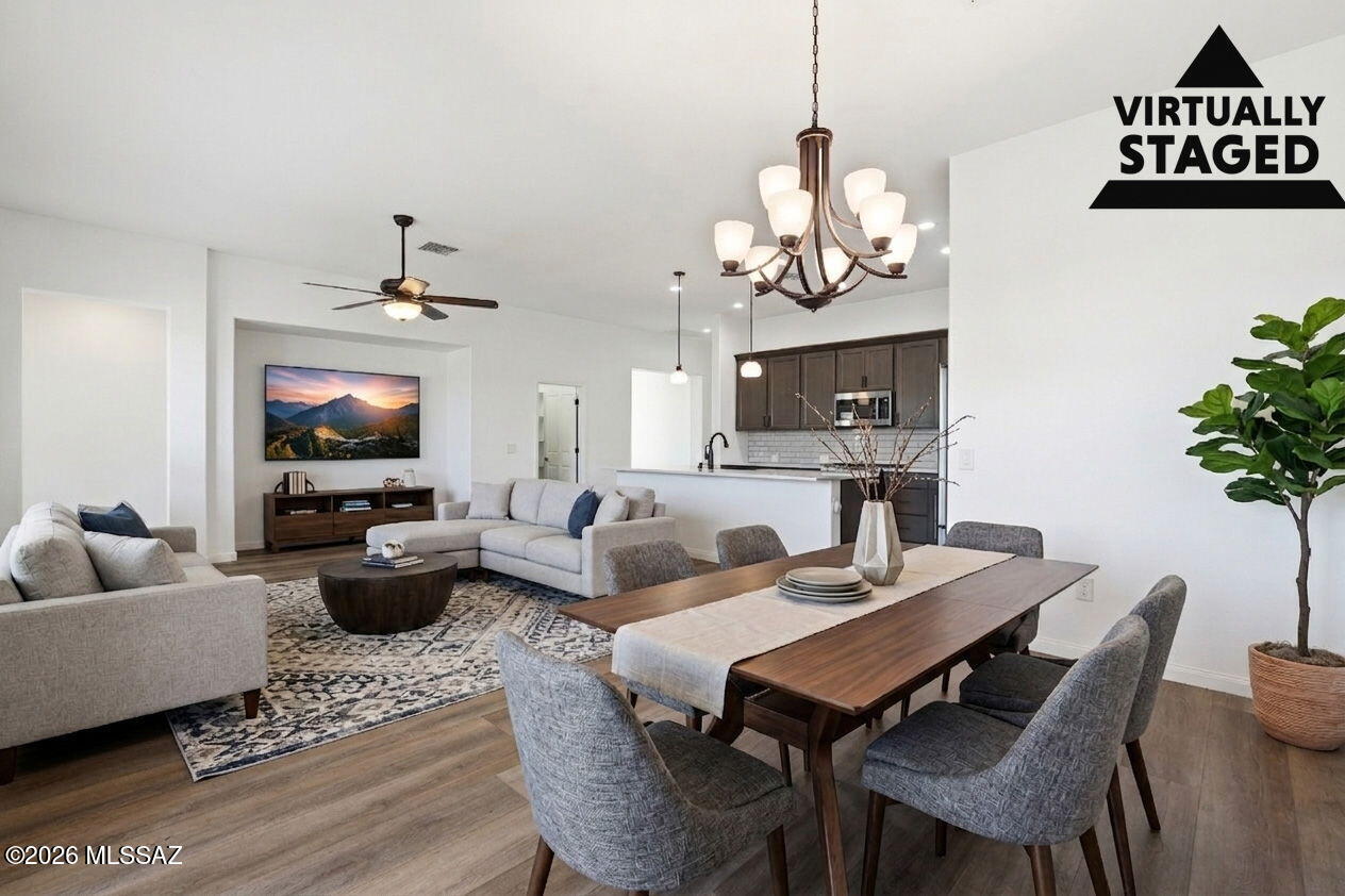 Move-in ready and beautifully maintained, this 2-bedroom, 2-bath + den VIVA model offers comfort, style, and easy Arizona living. Fresh interior paint and plank flooring create a clean, modern feel throughout the open-concept floorplan. The kitchen features stainless steel appliances, a gas range, ample cabinetry, and generous counter space. The spacious den is perfect for a home office or hobby room. Enjoy Arizona evenings on the paved patio. The oversized 2-car garage includes coated concrete flooring, utility sink, water softener, and built-in storage cabinets. HOA covers exterior paint, landscaping, irrigation, pest control, and roof maintenance for low-maintenance living.