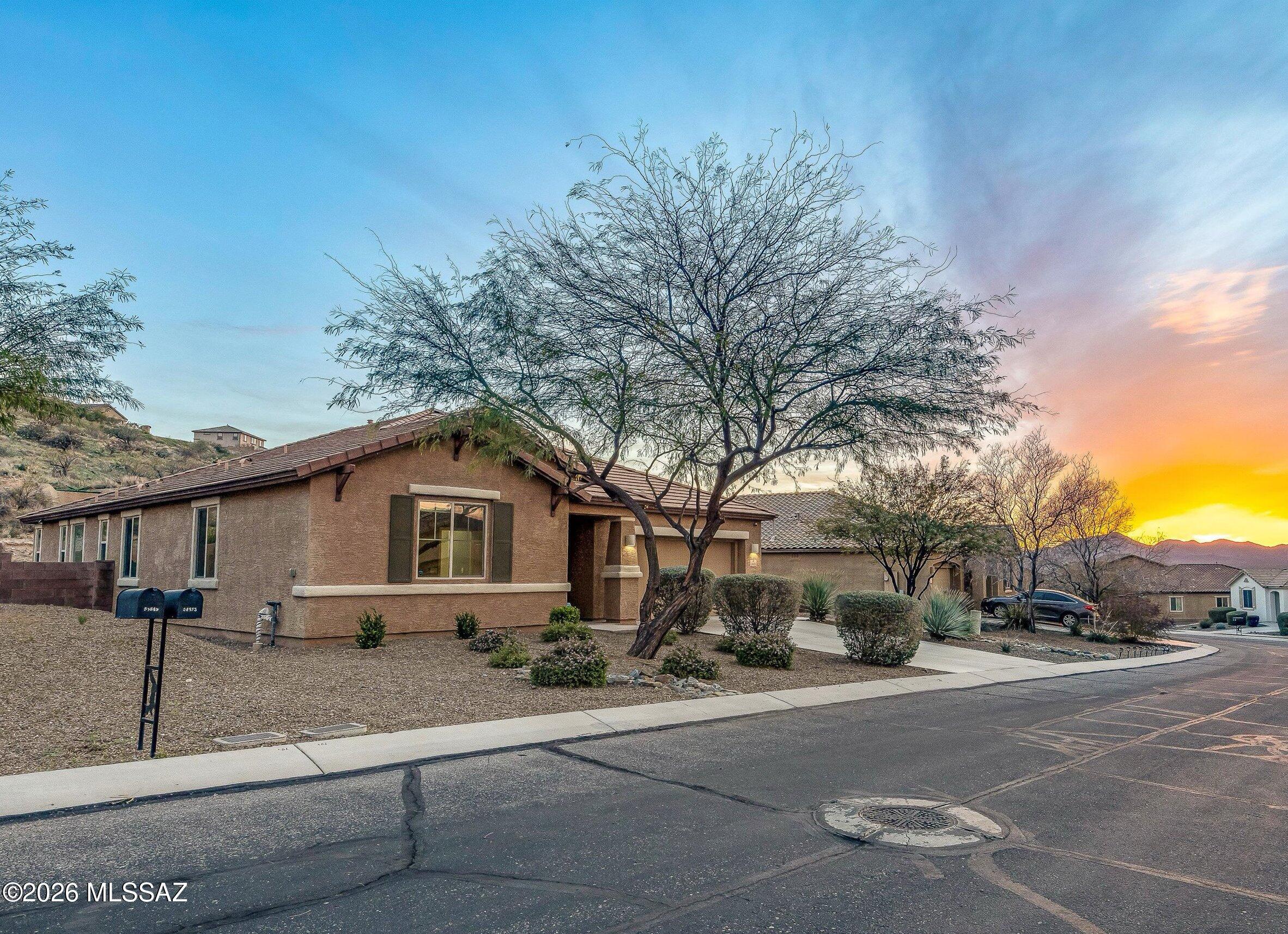 This spotless 3-bed 2-bath home with an additional den/office is freshly painted and ready for move-in! Many upgrades include tile flooring throughout, and a chef's kitchen with a huge island & walk-in pantry, stainless appliances, gas range, and wine fridge. The large primary suite features two walk-in closets, a soaking tub, & separate shower. The property backs to common area for incredible privacy, and the elevated lot features sunset views of the Tortolita mountains. The fenced-in backyard has a large covered patio, decorative turf, and a built-in charcoal bbq area. Come enjoy the community of Eagle Crest Ranch!