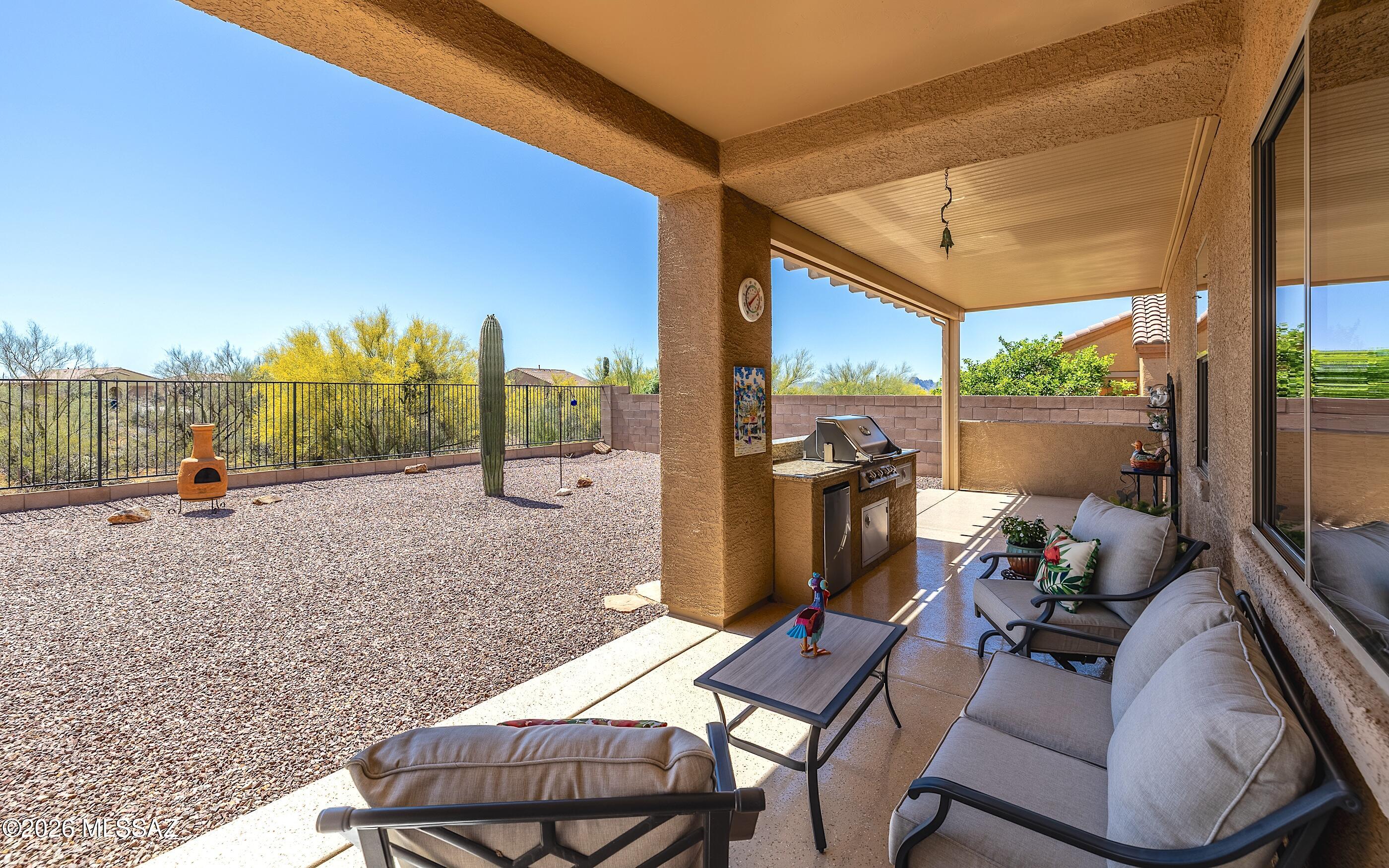 Improved Price! An impeccable Ranier model home in gated Preserve at Dove Mountain.  Immaculately clean, neat and pristine. Shows perfectly.  Full 3 car garage -3 bedrooms, open gourmet kitchen to relaxing and inviting family room. One of the most expansive/elongated rear patio decks in the subdivision w/built in BBQ station. Very spacious ''pool sized'' yard. Nicely graveled w/easy care landscape. Backing to natural desert landscape you will feel tranquility and nature just invites itself into your outdoor life. Lovely plantation shutters inside along with beautiful tile flooring throughout most of home except bedrooms.  Spacious garage has built in cabinets and epoxy floor. Brand new HVAC system just replaced March 2026!  This home is in excellent condition, shows absolutely fabulously. Property Highlights:
Size: 2,086 Sq Ft | Spotless condition inside & out
Parking: Rare 3-Car Garage
Location: Secure, quiet gated community
The Lot: Premium lot backing directly to a private desert wash (no rear neighbors!)
Outdoor Living: Massive 40x10 covered patio with a custom, built-in granite BBQ island
This is a premier lot and layout that natural desert-loving buyers will fall in love with.