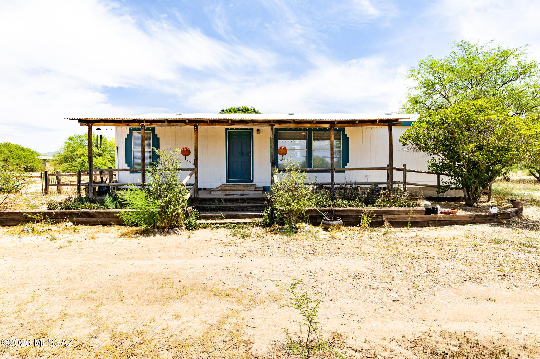 Enjoy country living with room to roam on just over 4 acres of fully fenced property. This well-maintained 3 bedroom 2 bathroom manufactured home offers comfortable living along with a separate 1 bedroom 1 bathroom guest home that is great for family, guests, a home office or potential rental income. Property includes large barn style storage area, full RV hook ups and a round pen for horses. Located on a quiet road, providing privacy and peaceful atmosphere while still having easy access to i10 and trips into town for shopping and dining. Bring your horses, toys and outdoor living ideas- this property is ready! Home is being sold ''as-is''. Home will be affixed at closing.