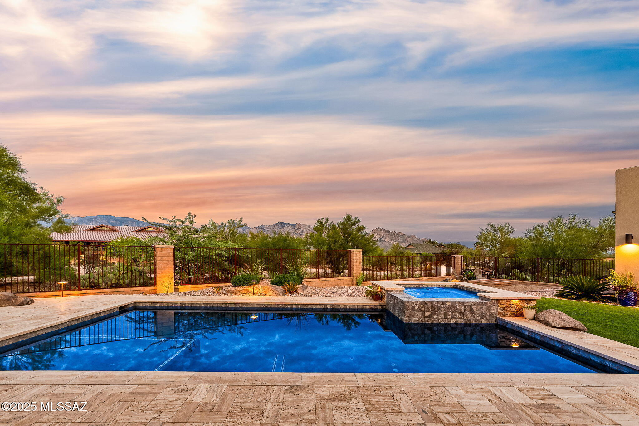 Suburban Ranch Dream Home in the heart of the Southwest desert, nestled against breathtaking mountain views, majestic southwest sunsets and abundant wildlife. Welcome to this stunning, custom-built 3-bedroom, 3 and a half bath residence which spans 3.31 acres of prime horse property with a charming pool house retreat and 360-degree view roof top deck. Perfectly blending luxury, relaxation and functionality this home is an entertainer's paradise and a haven for outdoor enthusiast. 
Interior features include a Gourmet kitchen with handcrafted knotty alder cabinets and sleek leathered granite countertops, expansive kitchen island perfect for gatherings and meal prep, high-end stainless-steel appliances, and a large walk-in pantry. Open-living spaces filled with floor to ceiling views. Pusch Ridge and remarkable natural light. Spacious bedrooms with ample storage, a modified jack and jill bathroom with separate vanity areas for each guest bedroom. Flawlessly designed alder cabinetry and doors throughout that elevate both form and function. The mindfully fashioned Primary bedroom includes his and hers walk-in closets, a luxurious bathroom with oversized shower, his and hers vanities, and a separate built-in safe room. 
Ideally situated for its unparallel mountain views and optimizing shade in the desert sun, is a sparkling pool and spa perfect for relaxing or hosting memorable gatherings. Timeless travertine decking and eco-friendly artificial turf add a touch of class to this already inviting yard. The recently completed 660' pool/entertainment house seamlessly connects indoor comfort with outdoor leisure, ideal for unwinding in style. Enclosed bathroom equipped with a refreshing shower, WC, and elegant vanity for ultimate convenience. It's open-concept design is complete with a built-in gas BBQ, solid concrete countertops with ample space to pull up to the bar for effortless outdoor dining, a warm and cozy, wood burning fireplace with a 70" TV mounted above, which creates the perfect hub for game days or movie nights under the stars. This addition is fully insulated and has its own water heater, 2 burner gas stovetop, and can possibly be converted into livable guest quarters. 
Ascend to the exclusive rooftop viewing deck, where sweeping panoramic city and mountain vistas await. Perfect for stargazing, morning coffee, and sunset gatherings. Whether you're hosting guests or seeking a serene escape this is the place you will always want to begin and end each day.
Additional amenities include an oversized 3 car garage with a separate workshop/storage room, durable low-maintenance drivit exterior finish for lasting beauty, and an expansive lot that offers a variety of options to expand on such as equestrian facilities, additional structures or simply enjoying nature and the wide open space.
Don't miss the chance to own this exceptional home. Schedule a viewing today and experience luxury desert living at it's finest.