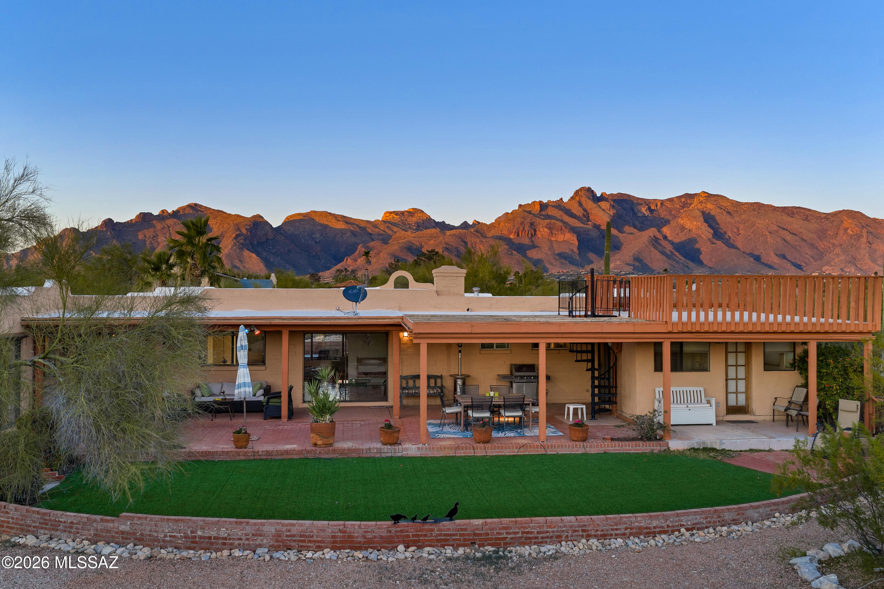 Fabulous 2656 SF home with 4 bedrooms, 3 baths plus an office in the ever popular Shadow Hills appropriately appointed to capture amazing mountain & city views! Some updating needed but is perfect setting to entertain with the right balance of indoor/outdoor spaces. The rooftop deck is glorious with views of the Catalinas, Rincons, Santa Ritas & the Tucson Mtns & city lights! The floorplan is split to allow for a dual primary suite, home office with separate entry,  OR a MIL/guest quarters should the need arise. Large .74 acre lot with space for a pool, etc. Quiet, peaceful, private & yet close to everything you might desire/need! Seller is MOTIVATED!