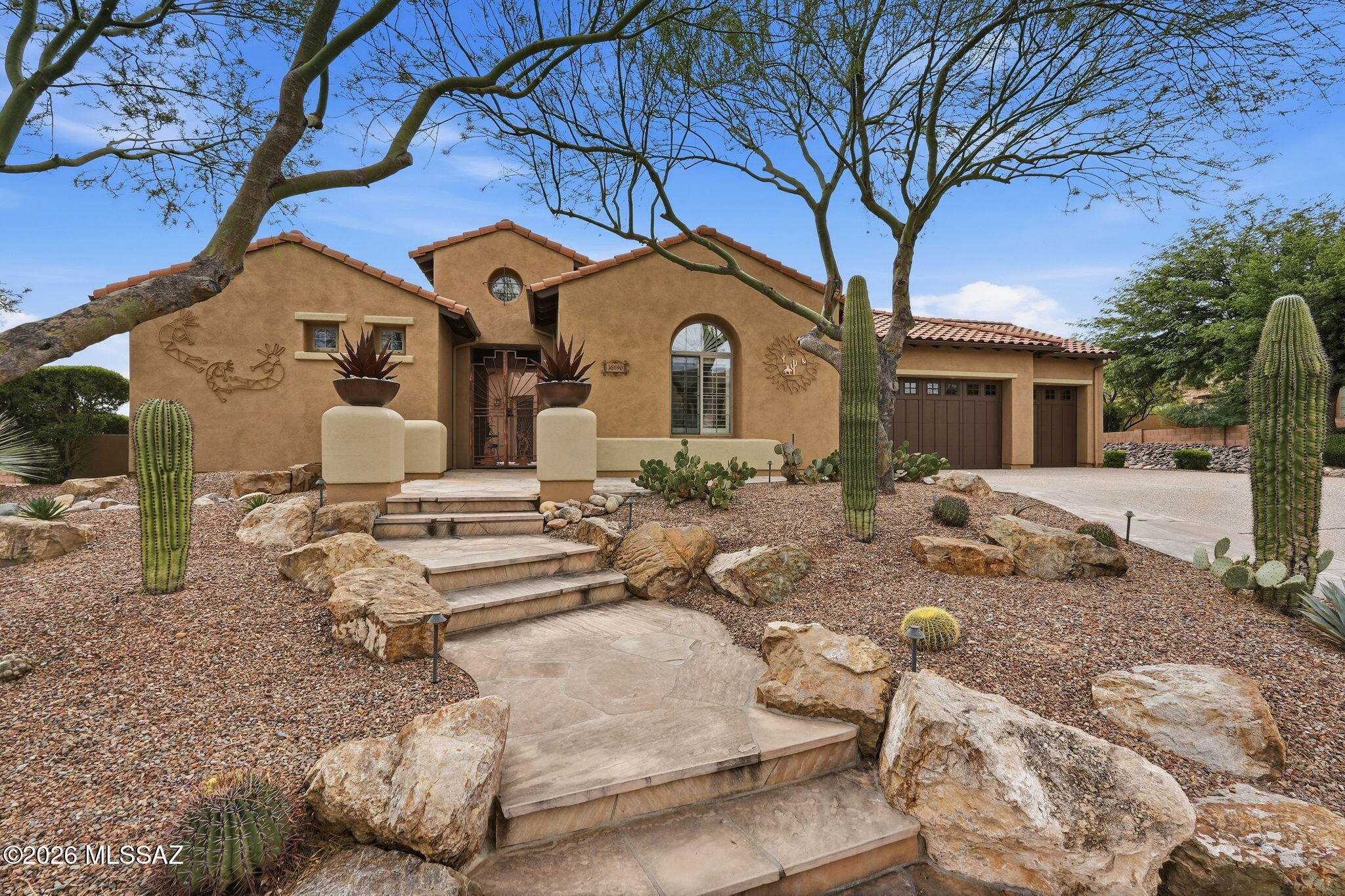 Fabulous view lot on this Sonoran Preserve model w/over $235K builder upgrades. Granite counters in kitchen w/hickory cabinets w/rollouts. Quartz counters all baths ,& surrounds. Solid alder interior doors. Flooring is tile throghout. Casita is equally appointed w/walk-in shower. Guest bedroom w/ensuite bath & vanity area. Separate office space. Cantera stone fireplace in great room w/ wiring throughout home for surround sound w/speakers. Kitchen w/built-in stainless fridge along w/dble oven & built-in microwave. 5'' Plantation Shutters. Iron doors on exterior doors & courtyard. Screened patio off master. Garage w/2 walls of cabinets, built-in vac, coated floor & laundry sink. Exterior flagstone landscaping w/hot tub complete the resort feeling. Insulation is blown-in blanket throughout.