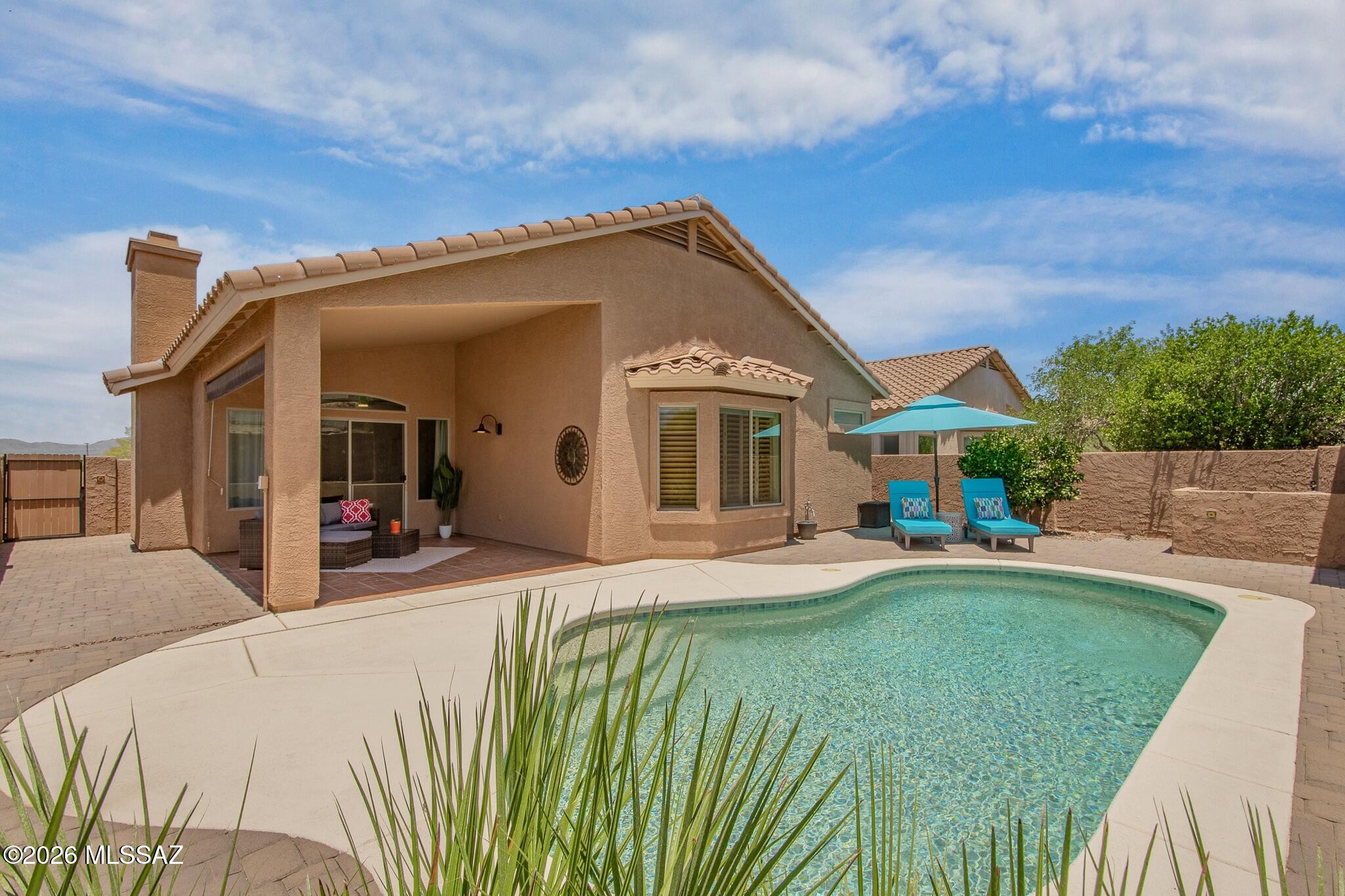 Exceptionally well maintained and truly move-in ready. This updated home combines features that are difficult to find together: a private pool, a separate den, a desirable split-bedroom floor plan, newer mechanical systems and roof, an epoxy garage floor, and Catalina Mountain views. For convenience, it can be purchased furnished, creating a rare turnkey opportunity for full-time living or a lock-and-leave seasonal retreat. The open great room features an updated stone fireplace with a wood mantel, while the versatile den is ideal for a home office, library, hobby room, or second living area. The updated kitchen offers granite countertops, stainless steel appliances, a gas range, pantry closet, breakfast bar, new lighting, and an adjoining dining area. The thoughtfully designed floor plan provides privacy for the primary suite while the secondary bedrooms are located on the opposite side of the home. Tastefully updated bathrooms include a custom walk-in shower. Additional quality features include plantation shutters throughout, tile and luxury plank flooring (no carpet), and an epoxy-coated garage floor.

The east-facing backyard is designed for year-round enjoyment, offering valuable afternoon shade, a covered patio, rolling sun screen, private pool, fully paved low-maintenance courtyard-style yard with terraced planters, a mature citrus tree, and Catalina Mountain views. The pool has been meticulously maintained and includes a new filter (2025), variable-speed pump (2026), and removable mesh safety fencing.

Significant improvements provide lasting value and peace of mind, including new tile roof underlayment (2025), new interior and exterior paint (2025-2026), a newer water heater (2024), and a well-maintained HVAC system replaced in 2013.

With extensive updates already completed and furnishings available, this home offers an exceptional turnkey opportunity for year-round living or as an easy lock-and-leave seasonal residence.