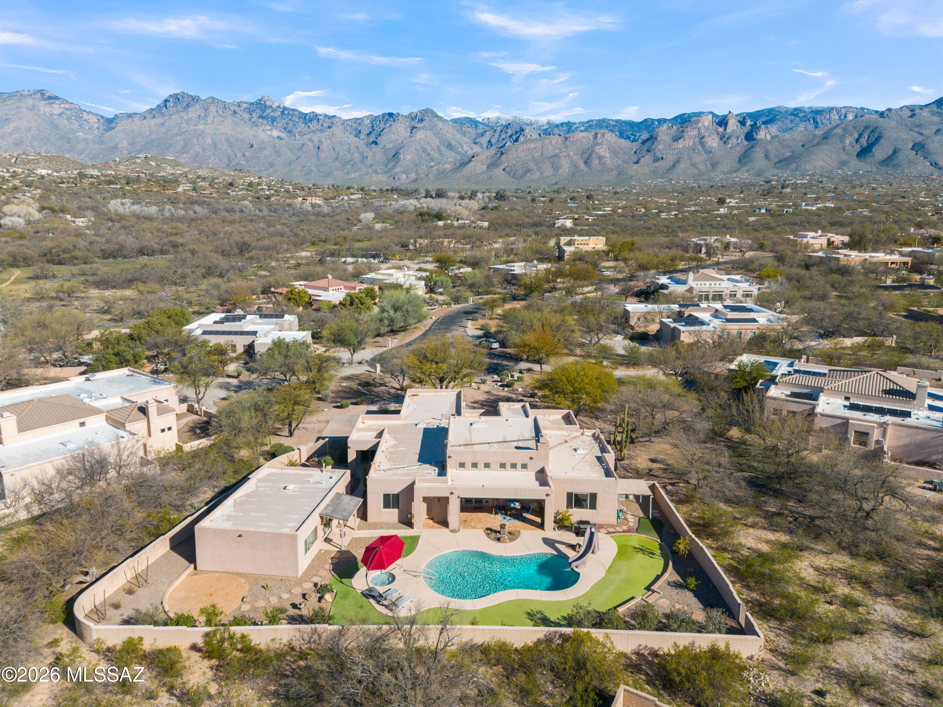 Welcome to a beautifully updated Bear Canyon Ranch retreat, tucked at the end of a quiet cul-de-sac on a .83-acre lot with sweeping mountain views. A charming courtyard welcomes you into the 3,229-sq-ft main home featuring a split-bedroom floor plan with 5 bedrooms, including a private junior suite, 3.5 baths, soaring 16-ft ceilings, home office, formal dining room, and a spacious great room with dining off the kitchen. The 3-car garage adds everyday convenience. The 864-sq-ft guest house offers a studio layout with built-in cabinetry, kitchenette, full bath, walk-in closet, storage, and its own laundry. The private backyard is an entertainer's dream with multiple patios, professional landscaping, mini-golf area, and a refinished pool and spa complete with an adult-sized slide. Must see !!