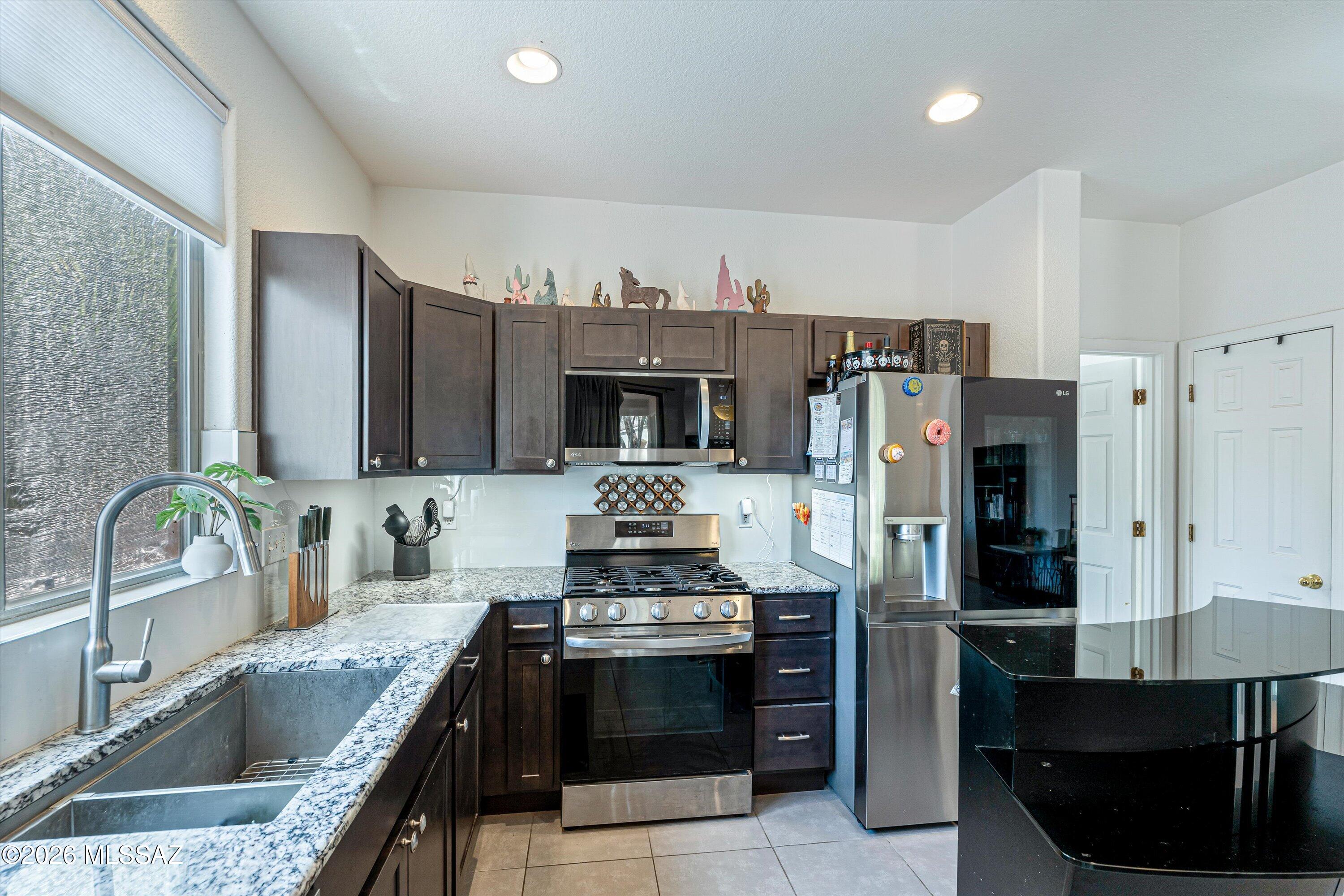Step inside & you'll immediately see how much care has gone into this 3 bedroom, 2 bathroom home. Bright, welcoming & beautifully updated, the open layout brings the living room, dining area & kitchen together, making it easy to picture mornings at the breakfast bar, dinner with friends & relaxing evenings at home. The completely remodeled kitchen features dark cabinetry, granite countertops, stainless steel appliances & a gas range. Both bathrooms are completely remodeled, with a tiled walk in shower in the primary suite & a jetted tub in the guest bath. Ceramic tile flows throughout & the HVAC is only a couple years old. Outside, low maintenance desert landscaping means more time to enjoy the Tucson lifestyle.