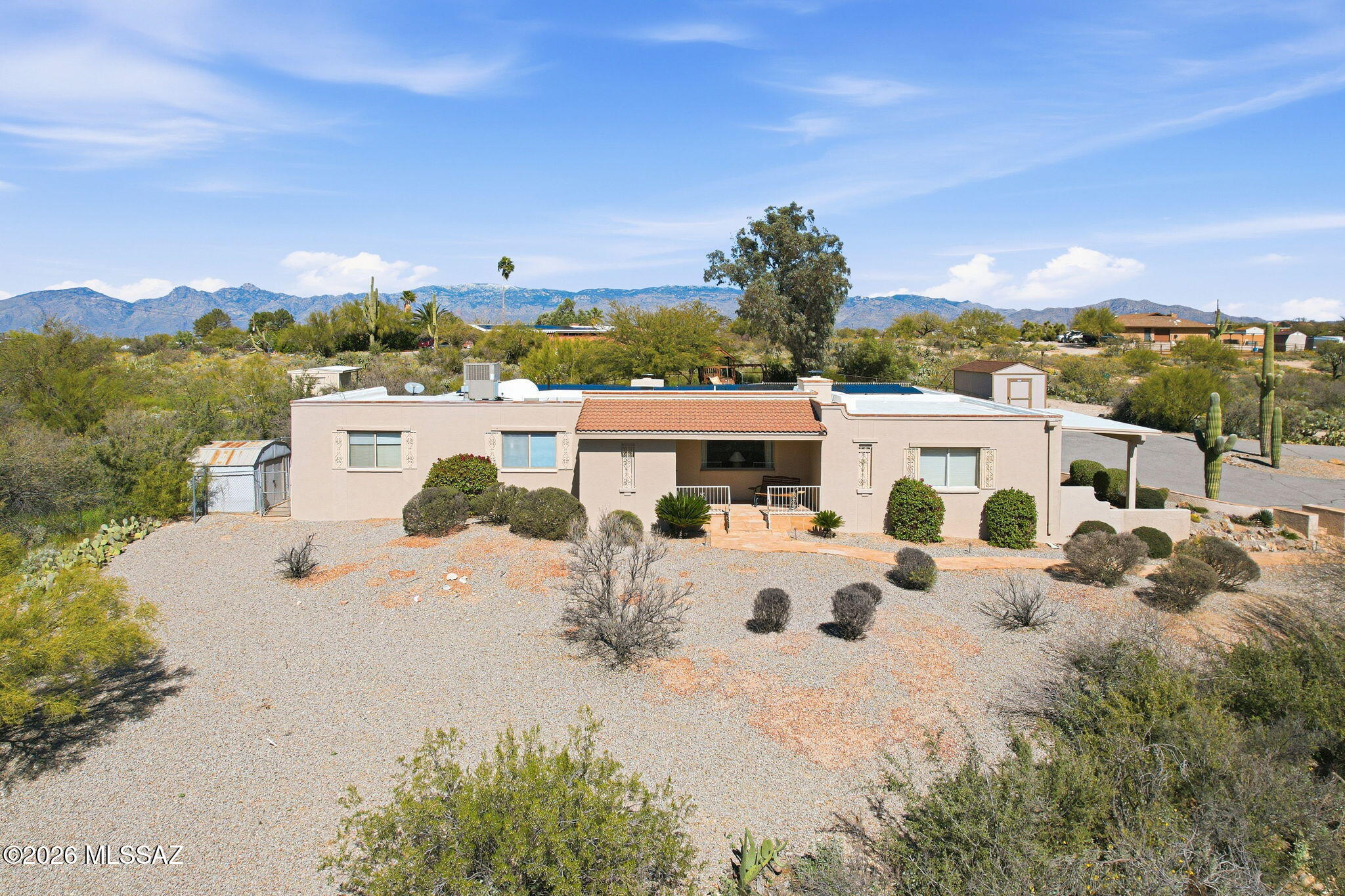 Escape to your own desert paradise on an expansive 3.4 acre estate. A flagstone walkway welcomes you through the entry to the comfortable living room, with fireplace! Generous dining room offers intimate space or plenty of room to expand for your holiday feast, with crackling fire place! The modern kitchen features a breakfast bar, buffet, stainless steel appliances and granite counters.
The primary bedroom features a remodeled bath & opens to a private covered patio for relaxation.
Enjoy 2 additional bedrooms & a double vanity guest bath. Party sized family room, perfect for game day & movie nights! Sparkling diving  pool with dramatic views! Reap the savings benefits of the owned solar system! 10 x16 tuff shed to convey with the property. Tack room, metal shed & playset convey as-is.