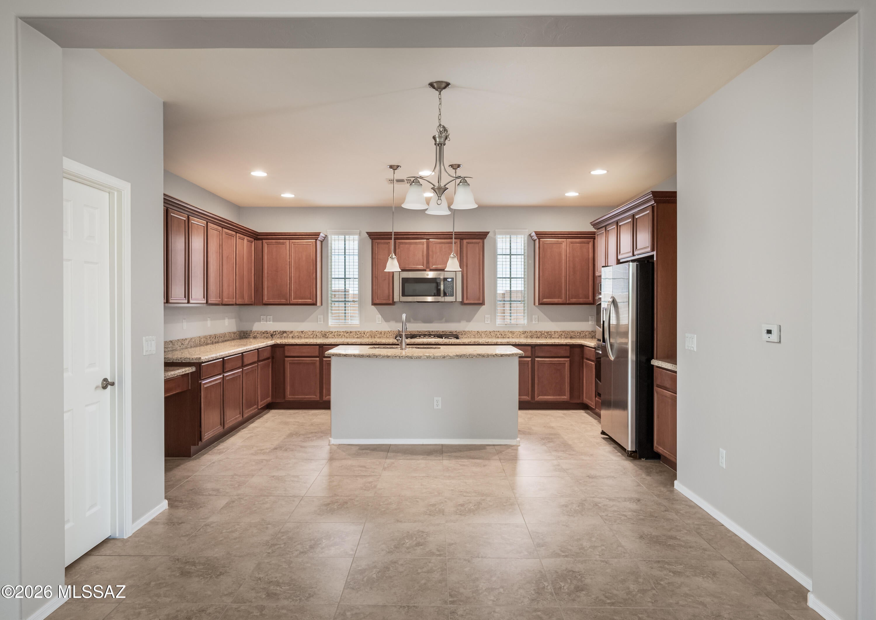 Immaculate and move-in ready, this 4-bedroom, 3-bathroom home in the gated Preserve at Dove Mountain features an open floor plan with tile flooring throughout the living areas. The spacious kitchen offers upgraded cabinets, granite countertops, a breakfast bar, a walk-in pantry, and abundant storage. Formal dining flows seamlessly into the great room, creating an ideal space for everyday living and entertaining.
The primary suite includes a large walk-in closet and a private bathroom with a separate tub and shower. Two additional full baths serve the remaining bedrooms. The home backs to a wash for added privacy and includes a 2-car garage. Ready for you to make this home!