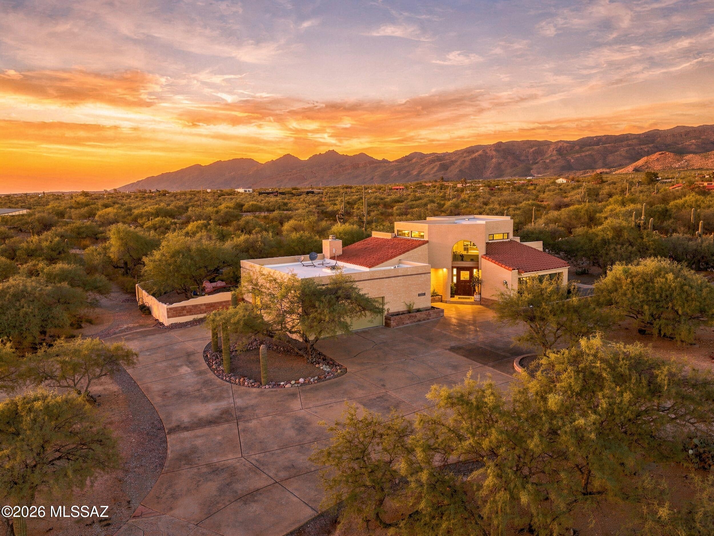Set against the stunning backdrop of the Rincon Mountains, this exceptional 3-bedroom, 3-bathroom home offers an incredible blend of privacy, entertaining space and relaxed desert living on 3.65 acres in desirable La Cebadilla Estates. From the moment you enter, soaring ceilings, expansive windows and beautiful mountain views create an inviting sense of space and connection to the surrounding landscape. The thoughtfully designed interior features both formal and casual living spaces, including a gracious formal sitting room with gorgeous views and a spacious family room. The gourmet kitchen is designed for both everyday living and entertaining, with a large center island, granite countertops, abundant maple cabinetry, stainless steel appliances and a generous walk-in pantry. A charming breakfast nook provides a casual dining option, while the formal dining room and adjacent bar area create an ideal setting for hosting family and friends. Upstairs, the private primary suite is perfectly positioned within the split-bedroom floor plan and offers a peaceful retreat with BEAUTIFUL Rincon Mountain views. Plantation shutters, a private patio, spacious walk-in closet, dual vanities and a relaxing jetted tub add comfort and character to this exceptional space. The secondary bedrooms are thoughtfully arranged with a large Jack-and-Jill closet providing convenient shared storage and functionality. Step outside and discover a true desert oasis designed for enjoying the Arizona lifestyle. The expansive 3.65-acre property provides room to spread out, with a chicken coop, sparkling Pebble Tec pool, putting green and a generous covered travertine patio creating multiple spaces for recreation, relaxation and entertaining. The mountain views provide a spectacular backdrop from both the home and grounds.
A spacious 2.5-car garage offers ample parking along with separate storage space for tools, equipment and outdoor gear. With its generous acreage, spectacular Rincon Mountain views, versatile living spaces and impressive outdoor amenities, this property offers a rare opportunity to enjoy privacy and space while remaining conveniently located in the Tanque Verde area.