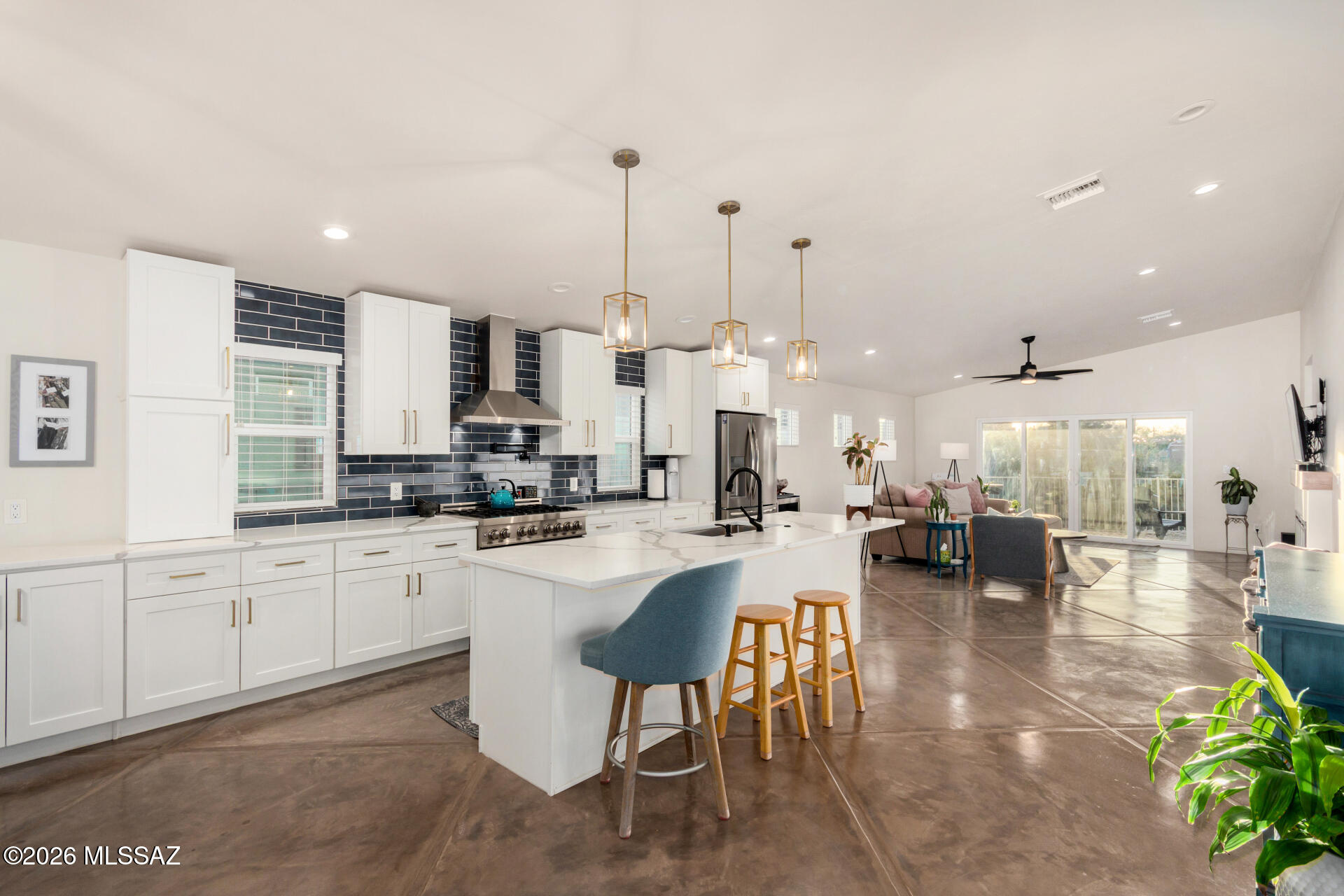 Take advantage of the low interest rates! Seller to counter or accept offers between $469,000-$485,000. Exceptional 2021-Built Contemporary Home offering DESIGNER FINISHES, Flexible Floor Plan, & ICONIC TUCSON SUNSETS. This well thought out home features 3 BEDROOMS, 2 BATHS + a versatile DEN/OFFICE that can easily convert to a 4TH BEDROOM. Designed w/ a desirable SPLIT-FLOORPLAN, STAMPED CONCRETE FLOORS, abundant natural light & a CHEF-INSPIRED KITCHEN w/ 36 IN. GAS RANGE & MASSIVE ISLAND. DESIGNER TILE, QUARTZ COUNTERS & EXTENSIVE CUSTOM CABINETRY throughout. Enjoy a BUILT-IN GAS FIREPLACE, spacious PRIMARY SUITE w/ WALK-IN CLOSET & SPA-LIKE BATH w/ WALK-IN SHOWER. Includes loop for whole-home water filtration system. WEST-FACING EXTENDED COVERED PORCH for stunning Tucson sunsets.  NO HOA
