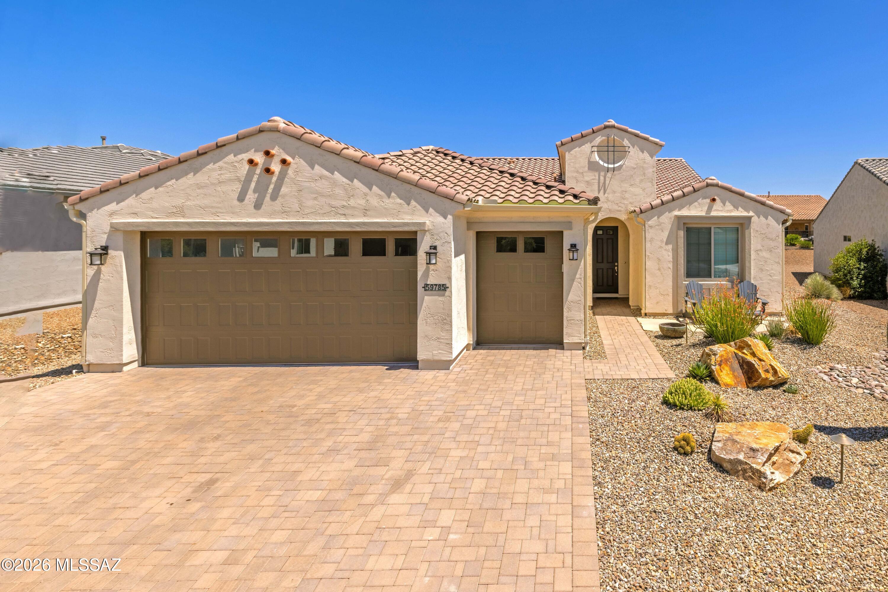 This Bella model in SaddleBrooke Ranch is one you won't want to miss -- single owner and it shows. The open layout flows beautifully with tile flooring throughout the main living areas and a kitchen that was clearly built with cooking in mind. Quartz countertops, upgraded cabinetry, a gas cooktop, and stainless LG appliances that all stay make this one truly move-in ready. The bar area with its wine fridge and sink is a nice bonus for entertaining.
Out back is where this home really separates itself. All done in 2026 -- a full outdoor kitchen, oversized pergola, extended paver patio, and new iron and stucco fencing give the backyard a polished, resort-like feel that's hard to find at this price point. The garage is a standout too. Extended four feet, golf cart bay, utility sink, and a water softener already in place -- exactly what Ranch buyers are looking for.
Inside, the master bath features a makeup vanity, blinds are throughout the home, and the den offers flexible space for a home office or guest room. 
Come experience everything SaddleBrooke Ranch has to offer -- golf, pickleball, pools, fitness, and a community that truly delivers on the active adult lifestyle.
