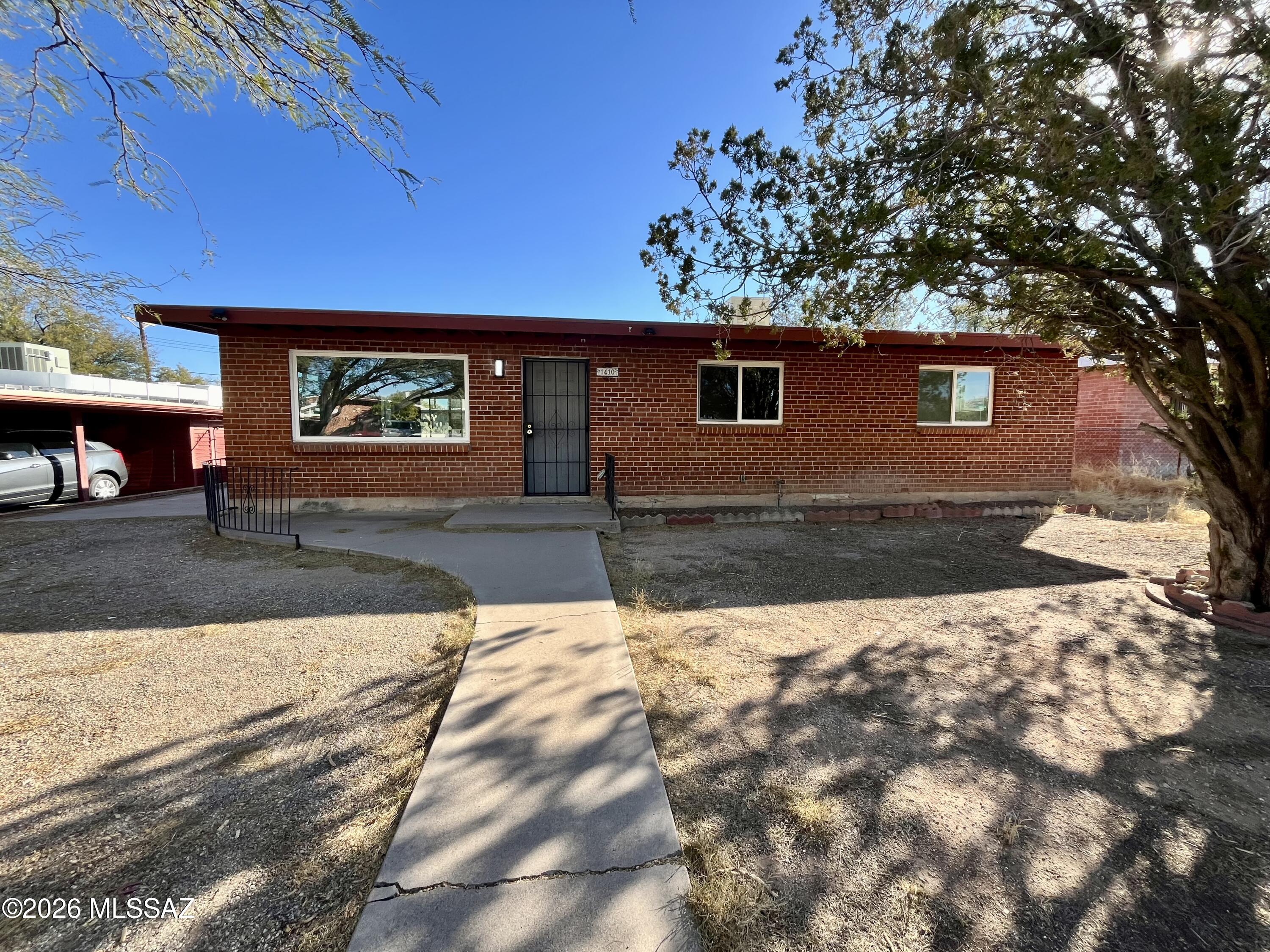Charming red brick ranch home located in Tucson's central area, offering 1,288 square feet of living space. This 3 bedroom, 2 bathroom property is set on a spacious 7,500 sq ft lot and features a large backyard enclosed by a block wall. Additional features include a storage room and shed in the rear yard. The home has a charming single-story layout and is conveniently located near Speedway and Columbus, with easy access to local amenities and the surrounding community. Zoned R-2 under Tucson municipality, the property falls within the TUSD school district, with Wright Elementary, Doolen Middle, and Catalina High as the nearby schools.