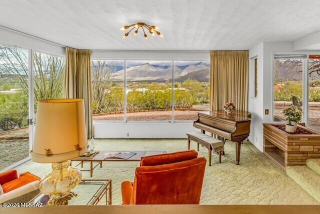 Set on 6.45 spectacular acres, this Mid-Century ranch home offers panoramic desert and mountain views in a quiet, natural setting surrounded by mature Sonoran desert vegetation. The generous parcel provides privacy and space rarely found, with the flexibility of no HOA.
A two car garage, room for horses or livestock to roam, and unparalleled vistas, make this time capsule an extraordinary experience to enjoy the Tanque Verde Valley. From the period lighting details, to the crisp lines that are a signature of the era, this residence is rich in virtues and vibes.
The home features four bedrooms and four bathrooms, along with additional office space suited for remote work or creative use. Walls of windows bring in natural light and frame the surrounding landscape, connecting the interior spaces to the desert beyond.
Architectural character defines the main living areas, where beamed ceilings and a substantial flagstone fireplace anchor the family room. Vintage bathrooms and period lighting preserve the home's original charm, while practical spaces like a large laundry room add everyday functionality.
Outside, a pool and small pool house/casita create an inviting setting for relaxing or entertaining while taking in the wide-open views. With expansive land, classic masonry construction, and timeless design elements, this property presents a unique opportunity to enjoy authentic Tucson living with room to grow.  (Casita is not included in square footage)