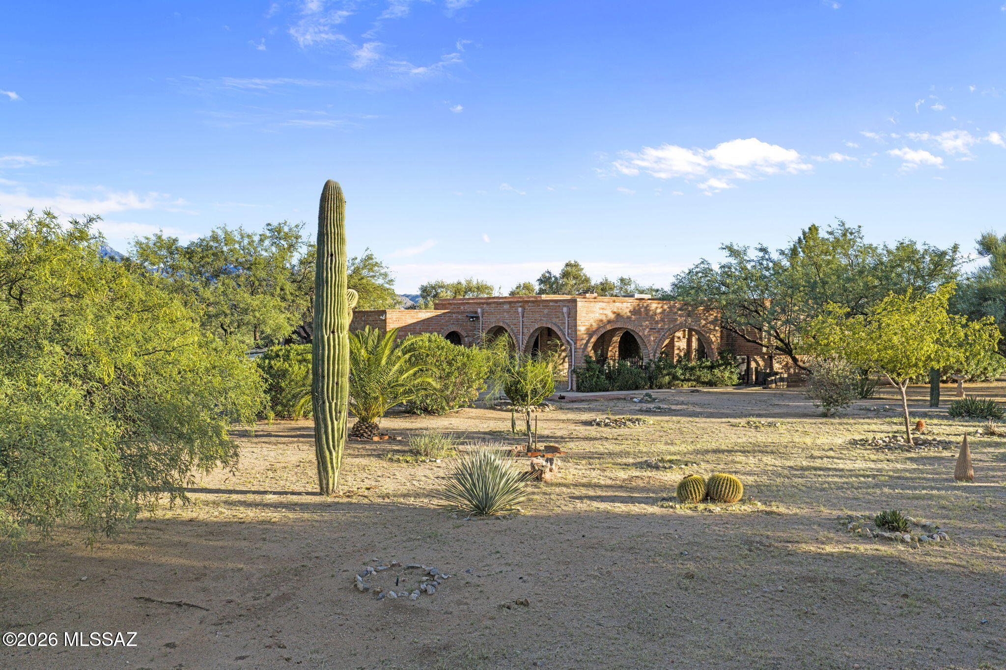 Classic Traditional architecture awaits and impressive exterior amenities!

With the welcoming curb appeal of Traditional architecture, this 3-bedroom, 2-bathroom charmer, within Green Valley Foothills in Green Valley , AZ, is a special opportunity. The area is prized by locals and home buyers. Soak in relaxing Mountain Views. The patio is ready for an afternoon outdoors. The spacious and low-maintenance yard sits on a corner lot. An open-air front porch and enclosed back porch extend your living space. Within, you'll find a stately entryway and a fireplace. Anchored by corian countertops, the expansive, stylish U-shaped kitchen invites culinary creativity. The primary bedroom features ensuite bath and walk-in closet for a true suite experience. The other 2 bedrooms are thoughtfully si The property is situated on 2.91 Acres. Located in a central part of the acreage, away from traffic noise and offering plenty of privacy, it has a large turnaround area that makes exiting the property a breeze. Expansive mountain views from the large Tiled rear Patio.
No HOA and not age-restricted. Great place to raise a family. A large enclosed, covered area with beautiful artificial grass for kids' enjoyment.