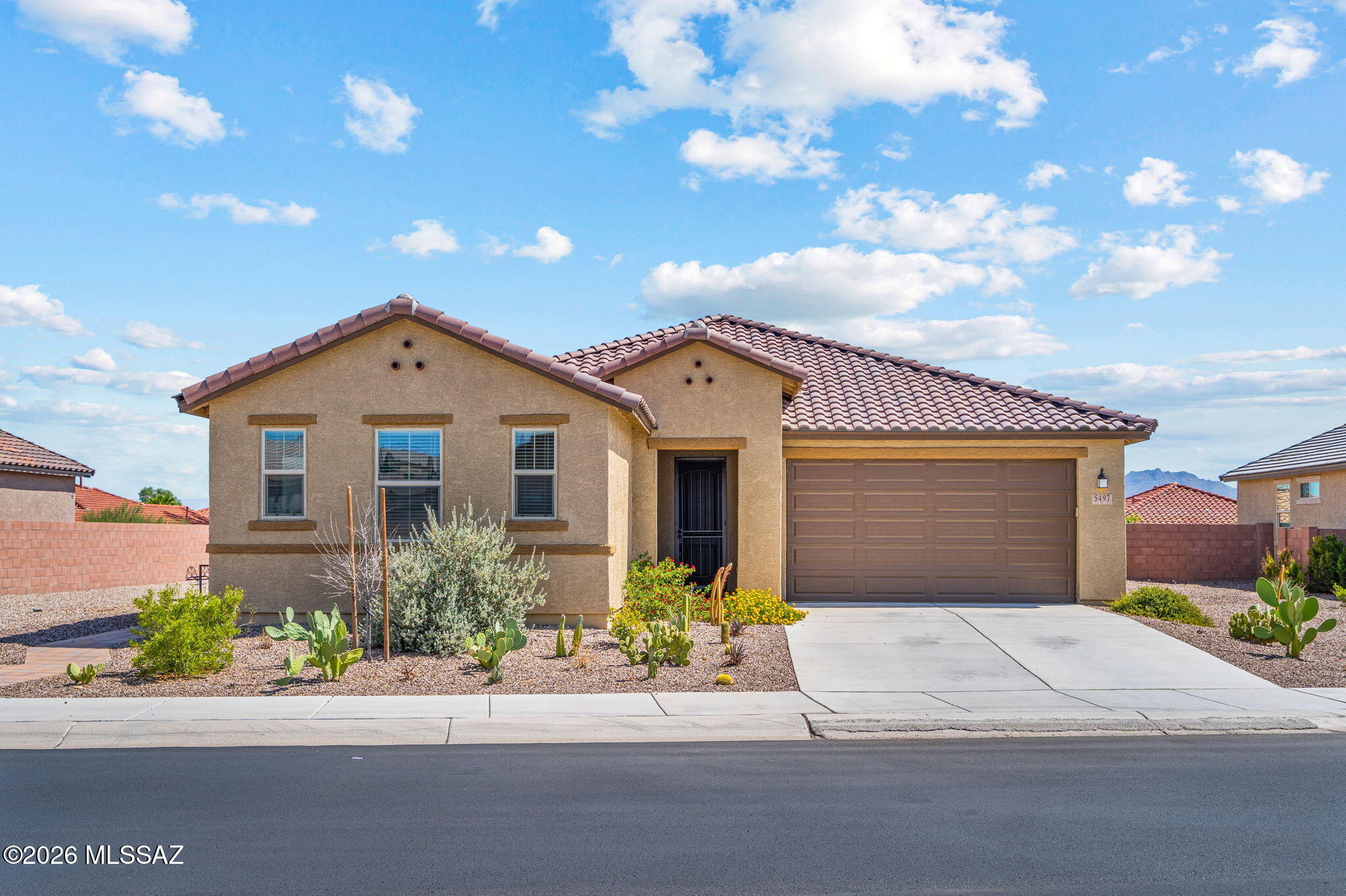 Enjoy the perks of new construction with a fully finished backyard in this spacious 4 bedroom, 2 bathroom home in the desirable De Anza community. Located just minutes from I-10 and countless shopping/dining amenities, this home merges the benefits of Northwest living with convenience to all Tucson's hot spots. Enjoy the large kitchen with ample counter space, walk-in pantry, and gas range. Storage cabinets in the laundry, plus a utility sink. Upgrades include a custom security door, and beautifully landscaped front and back yard with low maintenance care. Easily add your personal touches in this like-new home- schedule a tour today!