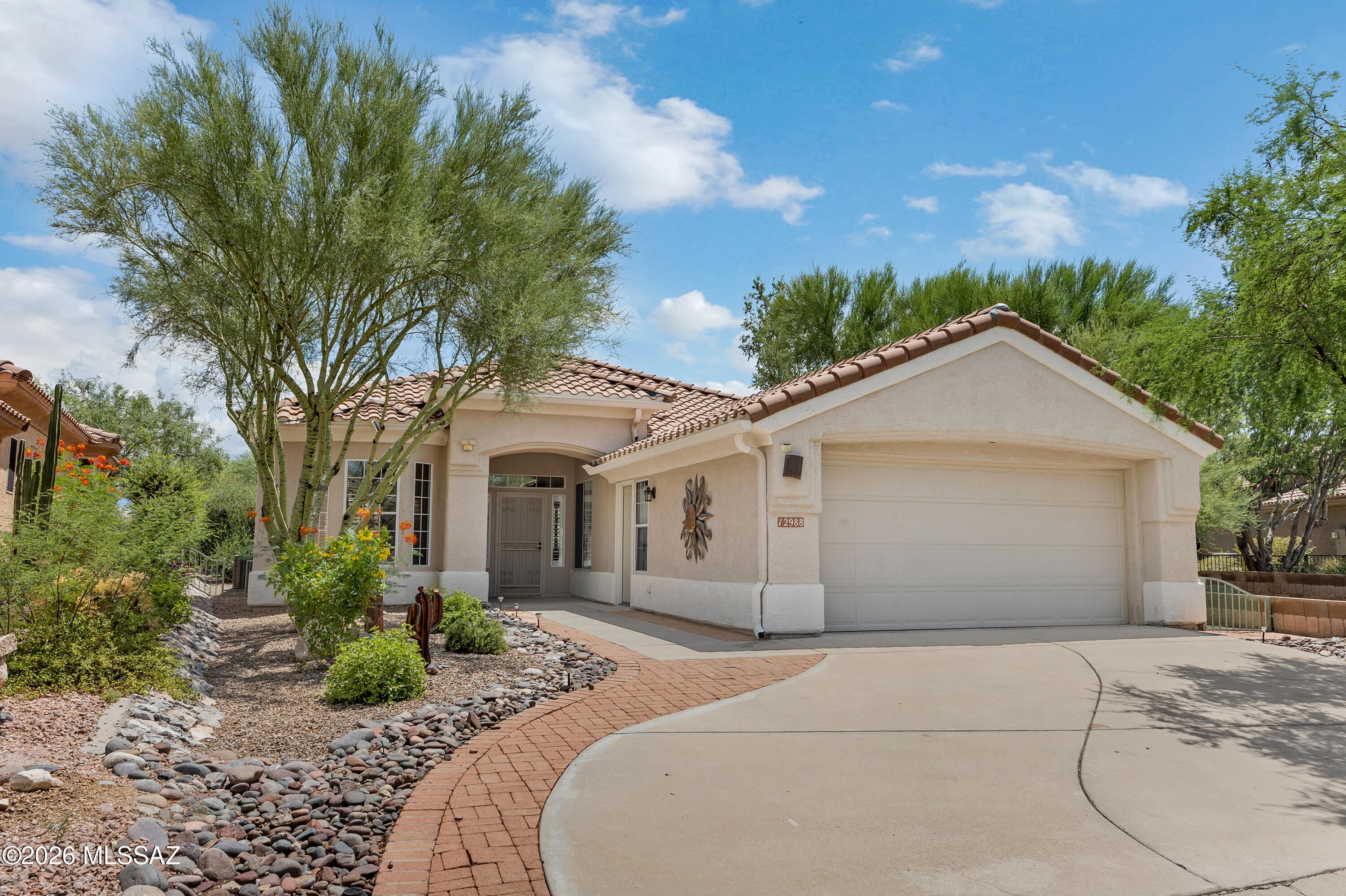 Experience the best of Arizona living in this beautifully upgraded and dual-extended Hillsboro model, perfectly positioned on an extra-wide lot overlooking the 8th fairway in the highly desirable Highlands at Dove Mountain. Enjoy breathtaking east-facing golf course, Catalina and Tortolita Mountain, and natural desert views--all from the comfort of your own backyard.

Step inside to a thoughtfully updated, turnkey interior featuring luxury vinyl plank and tile flooring throughout with no carpet for easy maintenance. The remodeled kitchen showcases quartz countertops, a lowered island/bar, and an open design that flows seamlessly into the great room. A stunning floor-to-ceiling stone fireplace creates an impressive focal point, complemented by a custom entertainment wall with abundant built-in storage. Plantation shutters throughout add timeless elegance and privacy.

The dual-extended floor plan provides exceptional versatility, including an oversized den/office nearly twice the standard size and an extended laundry room with extensive cabinetry and storage. Both bathrooms have been beautifully remodeled with quartz-topped vanities, while central vacuum adds everyday convenience. Additional peace of mind comes from roof underlayment replaced within the past year and a water heater replaced in January 2023.

Outdoor living is equally impressive with an expansive brick-paver patio, dual artificial turf areas, view fencing, and an extra-wide driveway. Relax while taking in spectacular mountain and fairway views and watching the abundant desert wildlife stroll along the golf course.

Whether you're searching for a full-time residence or the perfect seasonal escape from harsh winters, this exceptional Hillsboro offers the space, upgrades, views, and lifestyle you've been waiting for. Located within the beautiful active-adult community of The Highlands at Dove Mountain, this is Arizona living at its finest--schedule your private showing and experience it for yourself!