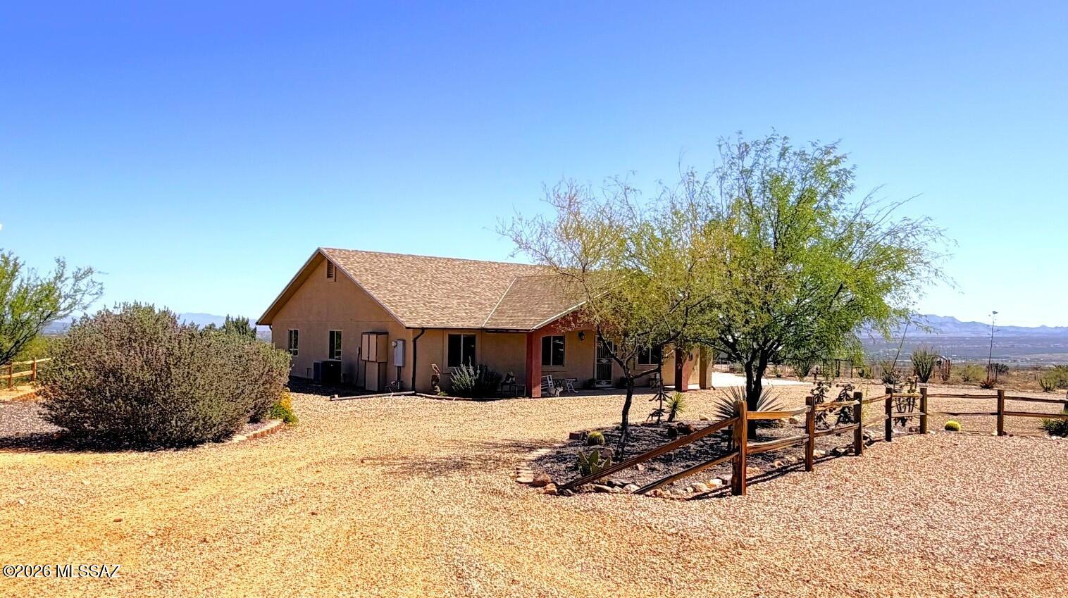 Experience peaceful country living with breathtaking mountain and desert views in Benson, AZ. Situated on approximately 4 cres, this custom-built 2019 home offers over 2,000 square feet of living space with the perfect blend of privacy, comfort, and modern Southwest charm. Enjoy wide-open skies, stunning sunrises and sunsets, and room to spread out while still being conveniently located near I-10 for an easy commute to Tucson or Sierra Vista. This property features spacious living areas, a desirable plan, and exceptional outdoor amenities designed for both relaxation and functionality. Unwind in the hot tub located on the covered back patio while taking in the stunning Arizona views. The property also includes multiple storage sheds, a greenhouse for gardening enthusiasts, and fruit trees that enhance the beauty and self-sufficiency of the land.
With ample space for horses, water filtration system, RV parking with 50amp hookup that also allows you to power the whole home with a generator incase of a power outage, outdoor entertaining, and recreational activities, this property offers endless possibilities. If you are looking for quiet country living with panoramic views, modern amenities, and unique extras, this Benson retreat is a must-see.