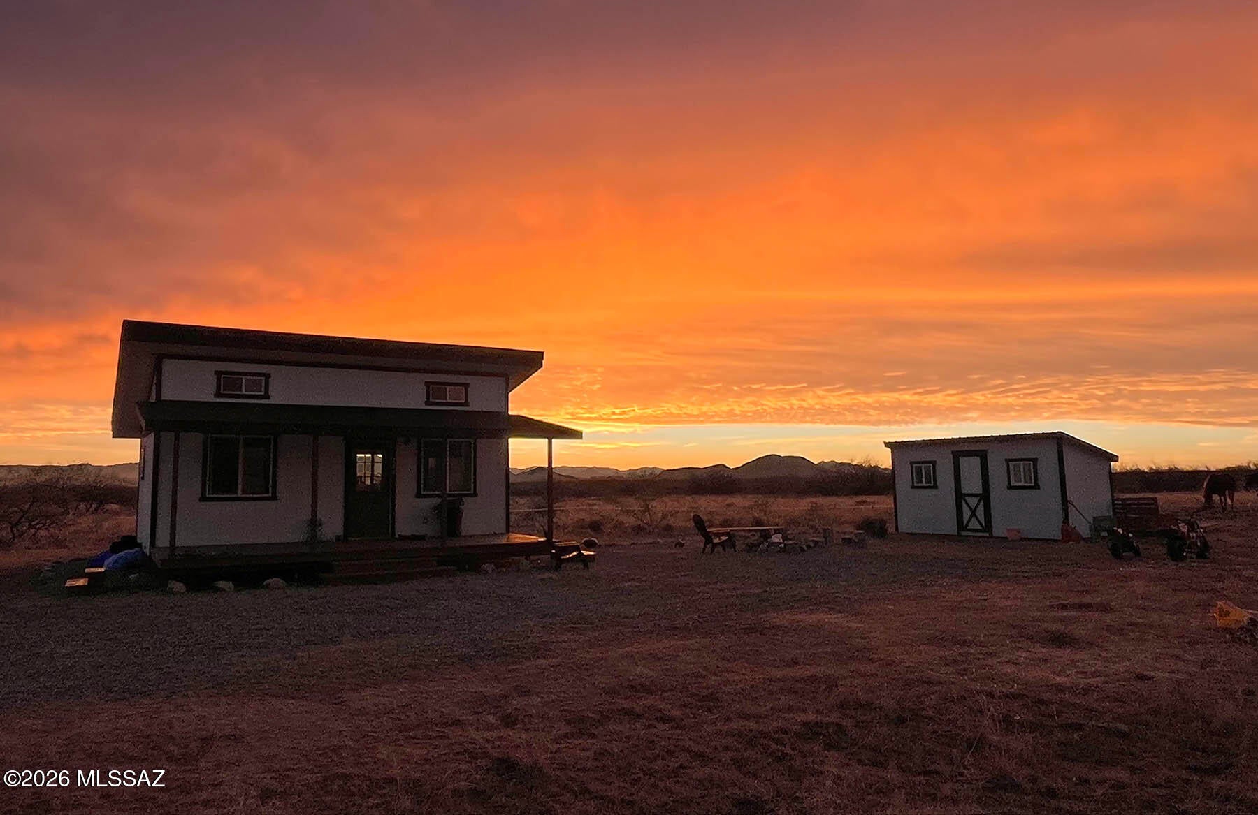 Nearly new (built 2025) off-grid tiny home on 1.7 acres with outstanding Dragoon Mountain views. The 384 sq ft cabin (24' x 16') features a large 8' x 24' covered porch perfect for enjoying desert sunsets and wildlife. Designed for comfortable off-grid living with solar power and battery storage, new septic system, storage shed, 2,200-gallon water storage tank with refill service, propane heat, on-demand hot water, propane range/oven, dual propane/electric refrigerator, and full-size washer & dryer. Interior includes custom knotty alder cabinets and a new bathroom with shower. 8' x 14' storage shed and furniture included. Corner lots on two county-maintained roads. No neighbors! A quiet high-desert setting ideal for a weekend getaways, country retreats, or full-time peaceful rural living.