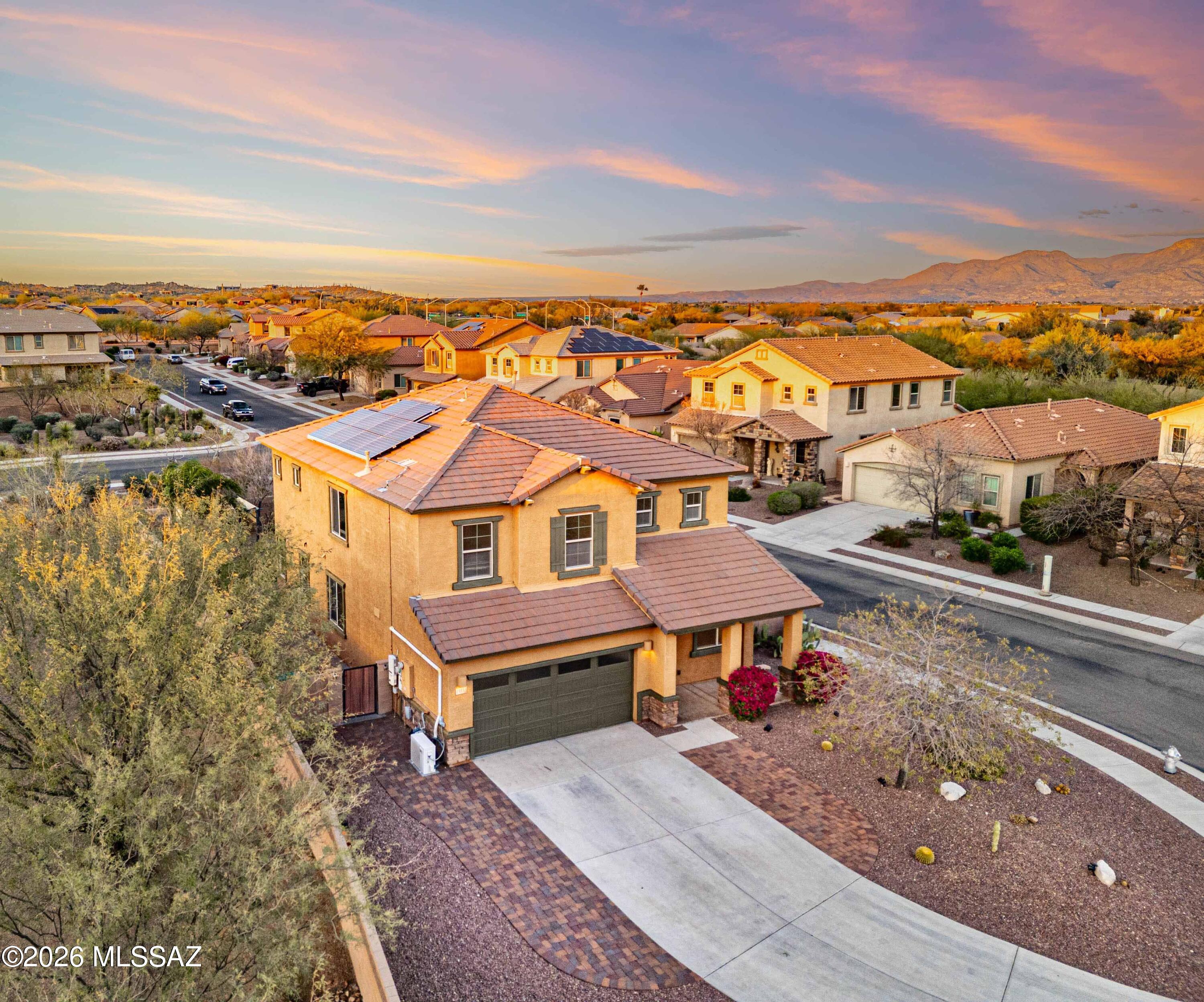 LOWERED PRICE!!! Welcome to this spacious 5-bedroom, 3-bathroom home offering 2,903 sq ft of living space in the highly desirable Rancho Vistoso community in Oro Valley. Situated on an oversized cul-de-sac corner lot, this property offers exceptional privacy with no adjacent neighbors. Inside, you'll find fresh interior paint and an inviting open floor plan filled with natural light. The main level features a large kitchen with granite countertops, a generous island, ample cabinetry, pantry, and stainless steel appliances including a gas range and nearly new dishwasher. The kitchen flows into two living areas and a dining space, making it perfect for entertaining or everyday living. A downstairs bedroom and full bathroom provide flexible space for guests, multigenerational living, or a home office.  Upstairs includes four additional bedrooms, two spacious full bathrooms with double vanities, a laundry room with washer and dryer, and a large den with beautiful mountain views. The primary suite features a spacious bedroom, private balcony, oversized walk-in closet, and a luxurious bathroom with a super-sized shower, double vanity, and private toilet room. The easy-care front and backyard feature newer turf, pavers, irrigation, and rock landscaping, along with mature palms and producing lemon, key lime, tangerine, and orange trees. The oversized backyard offers room for a swimming pool and includes a newer playground that can be removed prior to closing if desired. Additional highlights include a 2-car garage, extended driveway for extra parking, and 2023 HVAC system with warranty and updated thermostat. A number of fantastic schools to pick from in the area include neighborhood schools Painted Sky Elementary, Coronado K-8, Ironwood Ridge High School, and nearby charter schools including Innovation Academy, Leman Academy, and Basis Oro Valley.  Conveniently located within walking distance to parks, hiking trails, and the school bus stop, and just minutes from shopping, dining, schools, and Oro Valley Marketplace.  This lovely home is waiting for you!