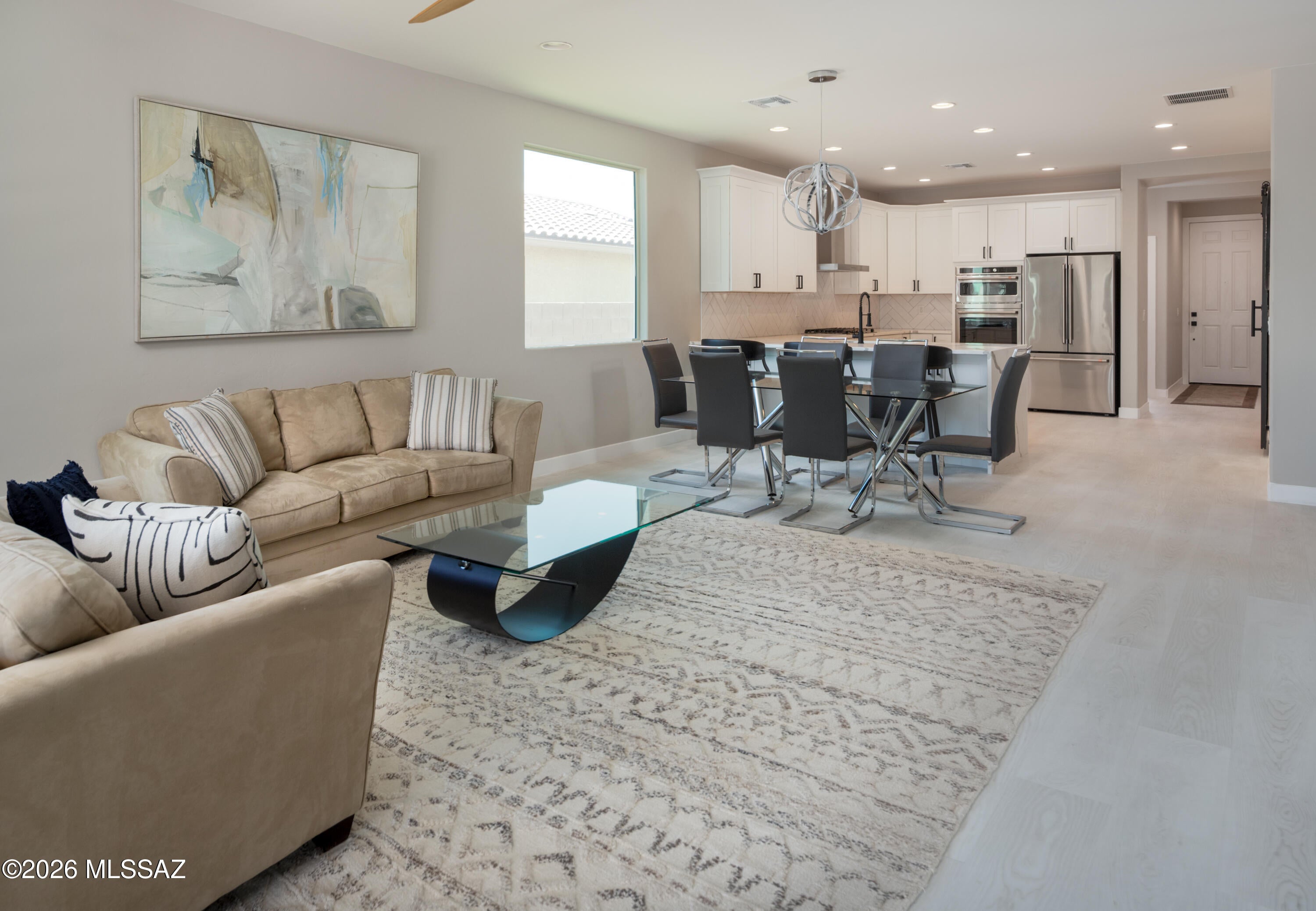 Completely remodeled and move-in ready, this 4-bedroom, 3-bathroom home in the gated Preserve at Dove Mountain features an open floor plan with tile flooring throughout the living areas. The chef's kitchen is an entertainer's delight, showcasing upgraded Shaker cabinets, quartz countertops, a breakfast bar, a full GE CafÃ© appliance package, a spacious pantry, and abundant storage. Built-in cabinetry enhances the open layout and provides plenty of practical storage.
The primary suite includes a large walk-in closet and a private bath with a separate tub and shower. Two additional full baths serve the remaining bedrooms. The home backs to a wash, offering enhanced privacy, and includes a 2-car garage. Ready for immediate occupancy.