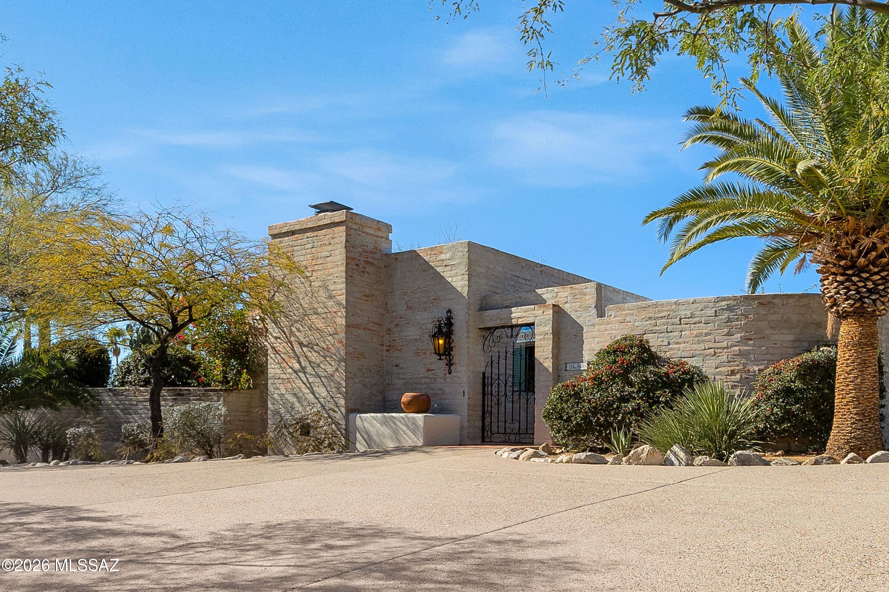 Nestled in the sought-after Coronado Foothills Estates, this 3 bedroom, 2 bath home blends classic Tucson charm with comfortable living. Built with timeless burnt adobe construction and a classic territorial design, it welcomes you through a private courtyard complete with a soothing fountain. Inside, you'll love the split bedroom floor plan, fresh interior paint, new carpet, and updated kitchen and baths. Step outside to an expansive covered rear patio overlooking a sparkling pool—perfect for relaxing or entertaining. The home is surrounded by lush desert beauty with towering saguaros and frequent visits from local wildlife including javalina, bobcats, hawks, rabbits, and roadrunners. This is Foothills living at its best.